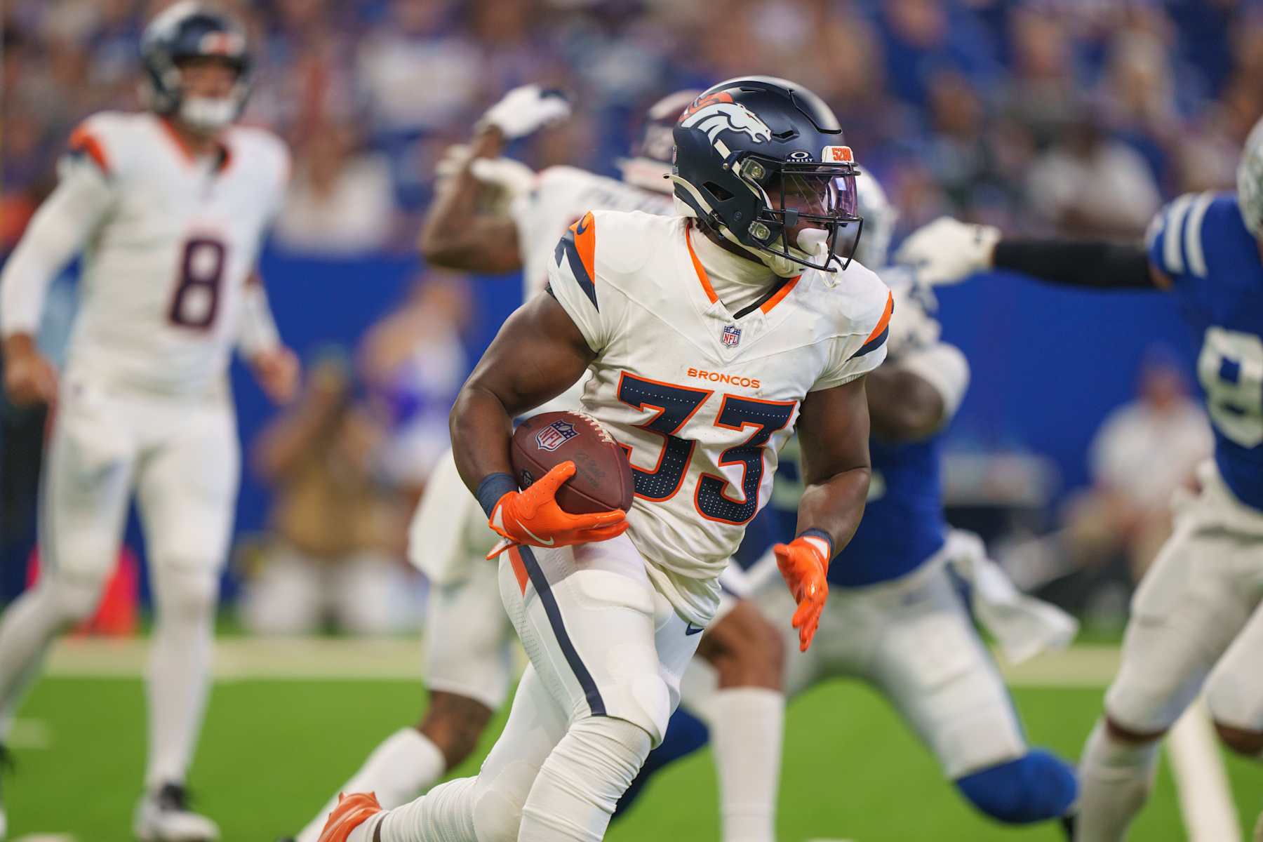INDIANAPOLIS, IN - AUGUST 11: Running back Javonte Williams #33 of the Denver Broncos runs with the ball during the first half of an NFL preseason football game against the Indianapolis Colts at Lucas Oil Stadium on August 11, 2024 in Indianapolis, Indiana. (Photo by Todd Rosenberg/Getty Images)