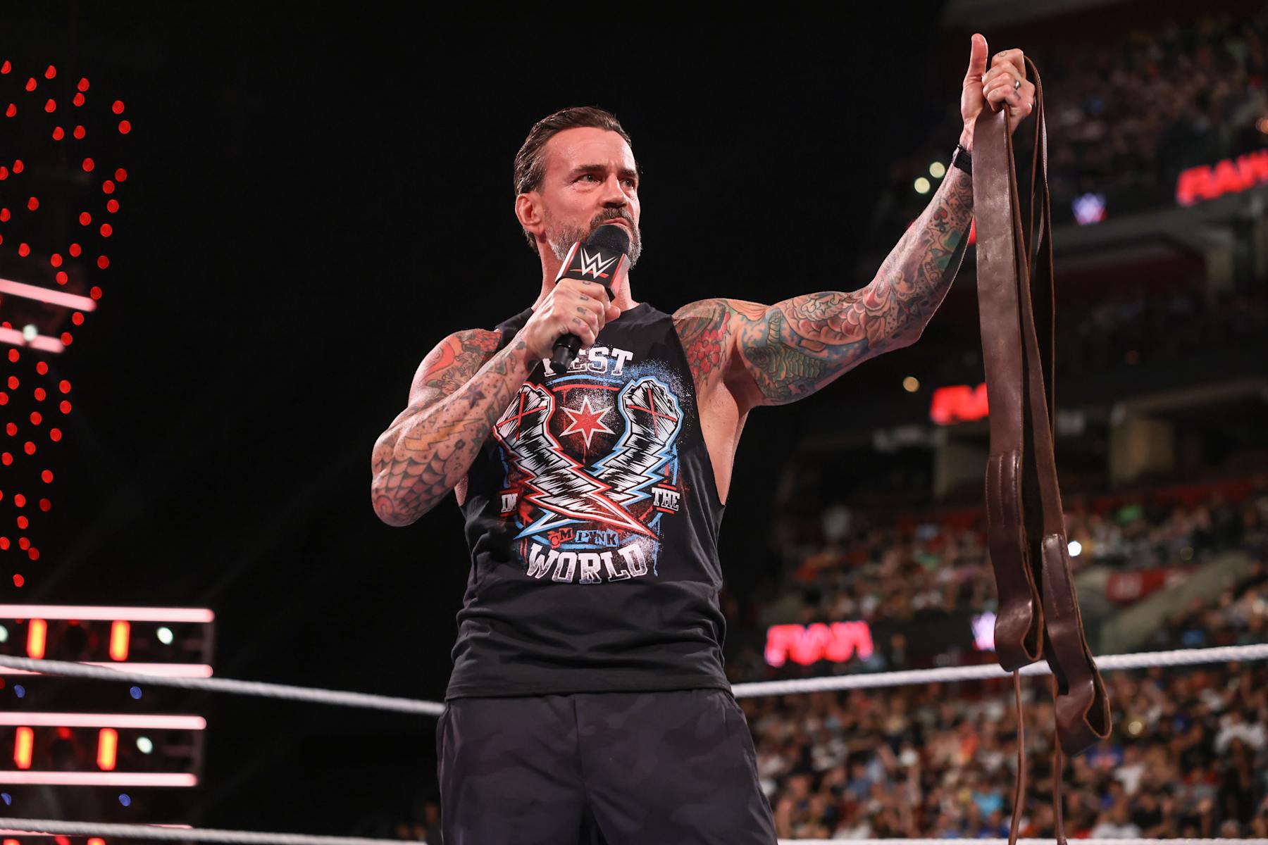 SUNRISE, FLORIDA - AUGUST 19: CM Punk speaks while holding a leather strap during Monday Night RAW at Amerant Bank Arena on August 19, 2024 in Sunrise, Florida. (Photo by WWE/Getty Images)