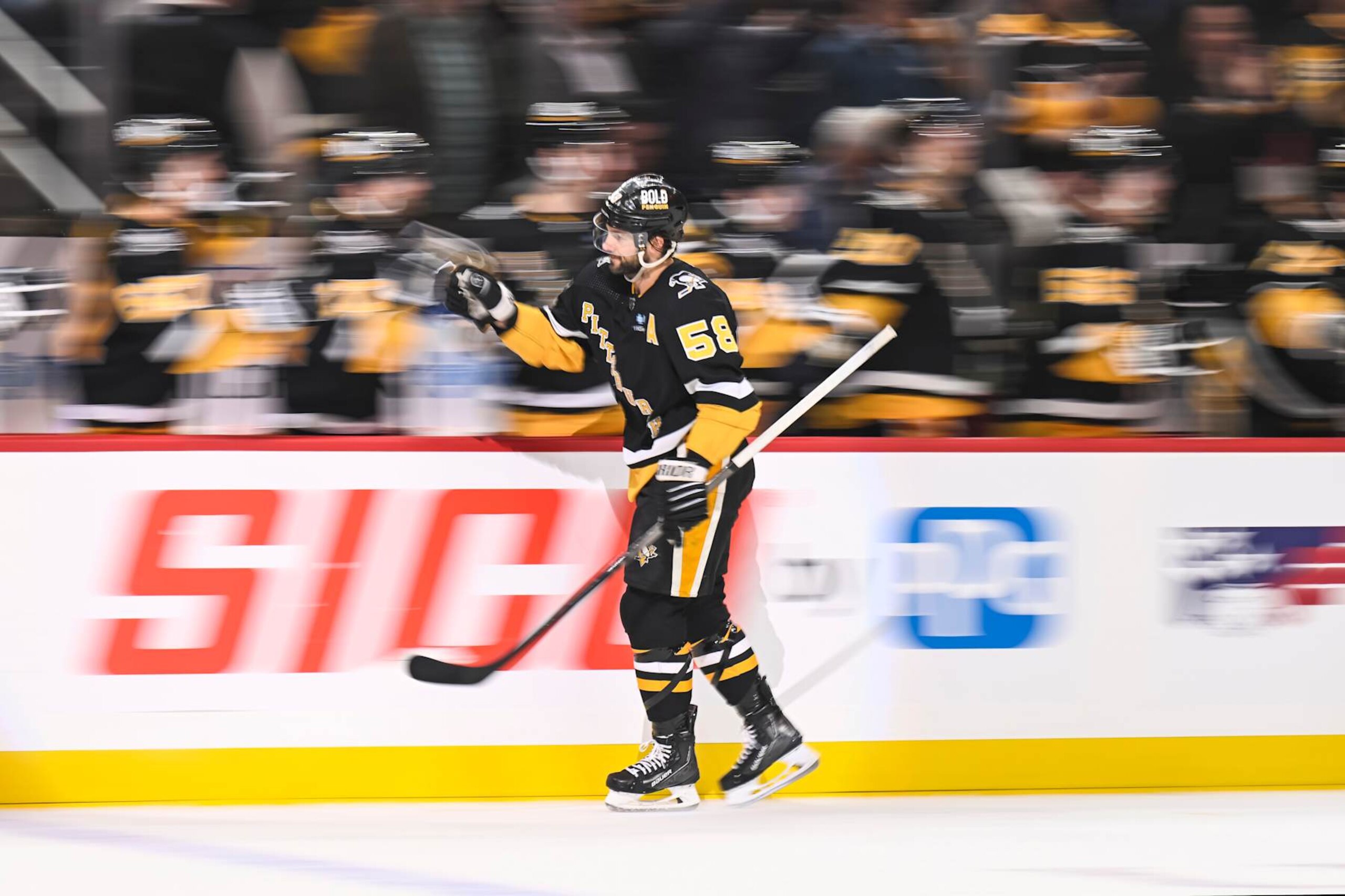 PITTSBURGH, PA - FEBRUARY 22: Pittsburgh Penguins defenseman Kris Letang (58) celebrates his goal with the bench during the first period in the NHL game between the Pittsburgh Penguins and the Montreal Canadiens on February 22, 2024, at PPG Paints Arena in Pittsburgh, PA. (Photo by Jeanine Leech/Icon Sportswire via Getty Images)