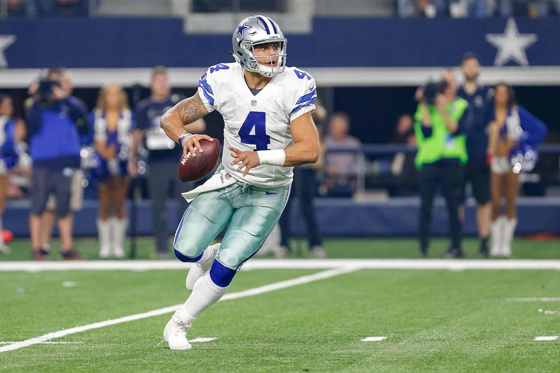 ARLINGTON, TX - DECEMBER 26: Dallas Cowboys Quarterback Dak Prescott (4) rolls out for a pass during the Monday Night Football game between the Detroit Lions and Dallas Cowboys on December 26, 2016, at  AT&T Stadium in Arlington, TX.  (Photo by Andrew Dieb/Icon Sportswire via Getty Images)
