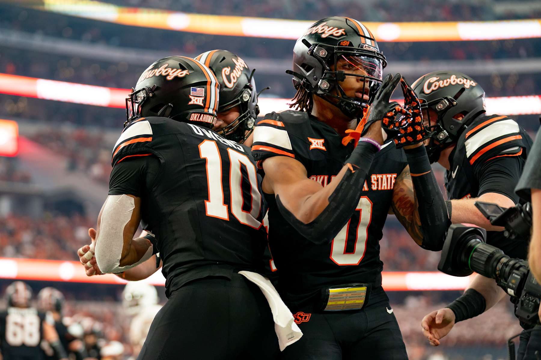 ARLINGTON, TX - DECEMBER 02: Oklahoma State Cowboys running back Ollie Gordon II (0) and Oklahoma State Cowboys wide receiver Rashod Owens (10) celebrate a touchdown during the Big 12 Championship game between the Texas Longhorns and the Oklahoma State Cowboys   on December 02, 2023 at AT&T Stadium in Arlington, TX. (Photo by Chris Leduc/Icon Sportswire via Getty Images)