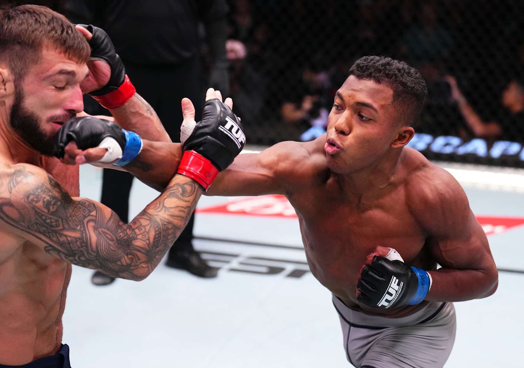 LAS VEGAS, NEVADA - AUGUST 24: (R-L) Mairon Santos of Brazil punches Kaan Ofli of Australia in a featherweight fight during the UFC Fight Night event at UFC APEX on August 24, 2024 in Las Vegas, Nevada. (Photo by Chris Unger/Zuffa LLC)