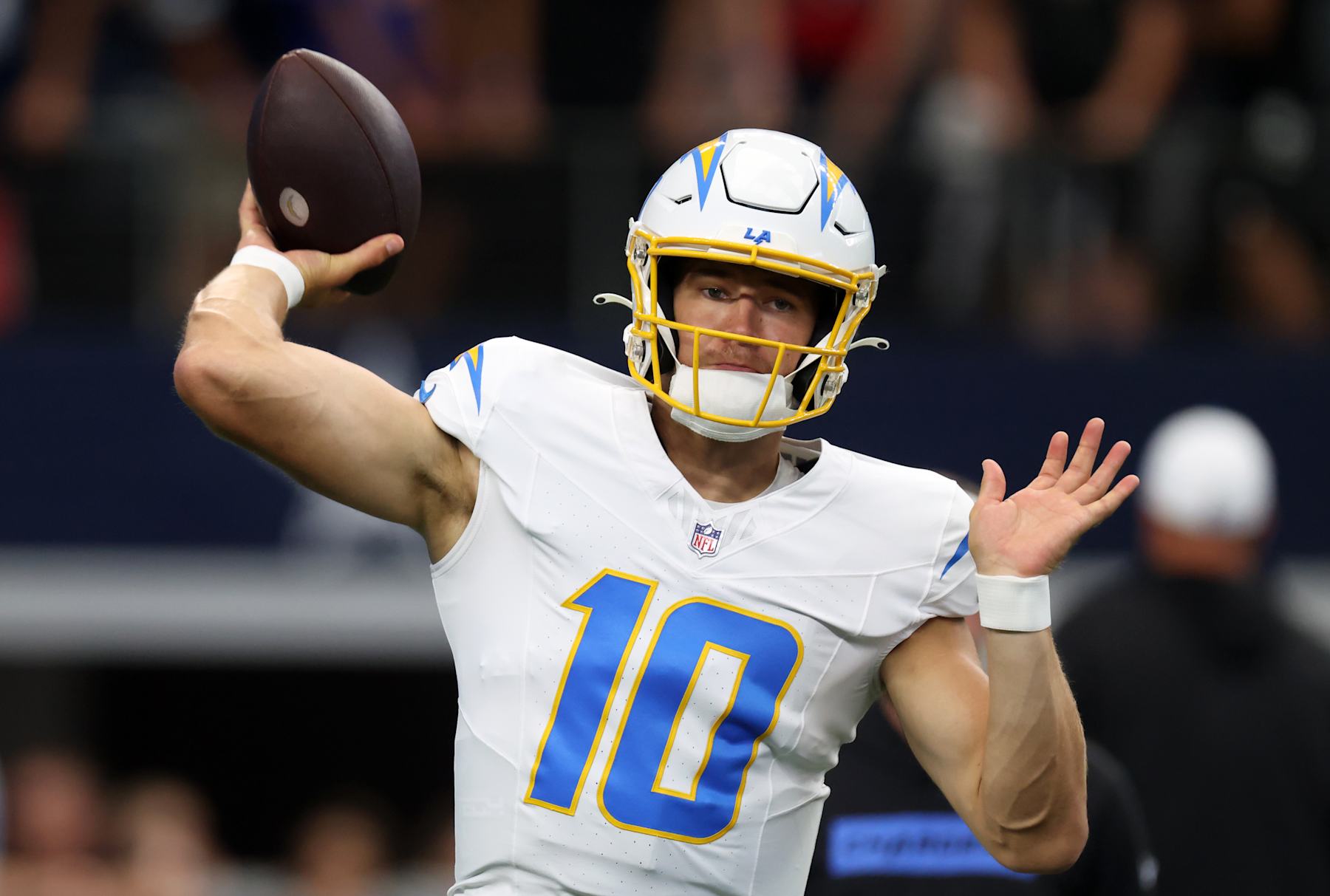ARLINGTON, TX - AUGUST 24: Justin Herbert #10 of the Los Angeles Chargers warms up before a preseason game between the Dallas Cowboys and the Los Angeles Chargers at AT&T Stadium on August 24, 2024 in Arlington, Texas. (Photo by Ron Jenkins/Getty Images)