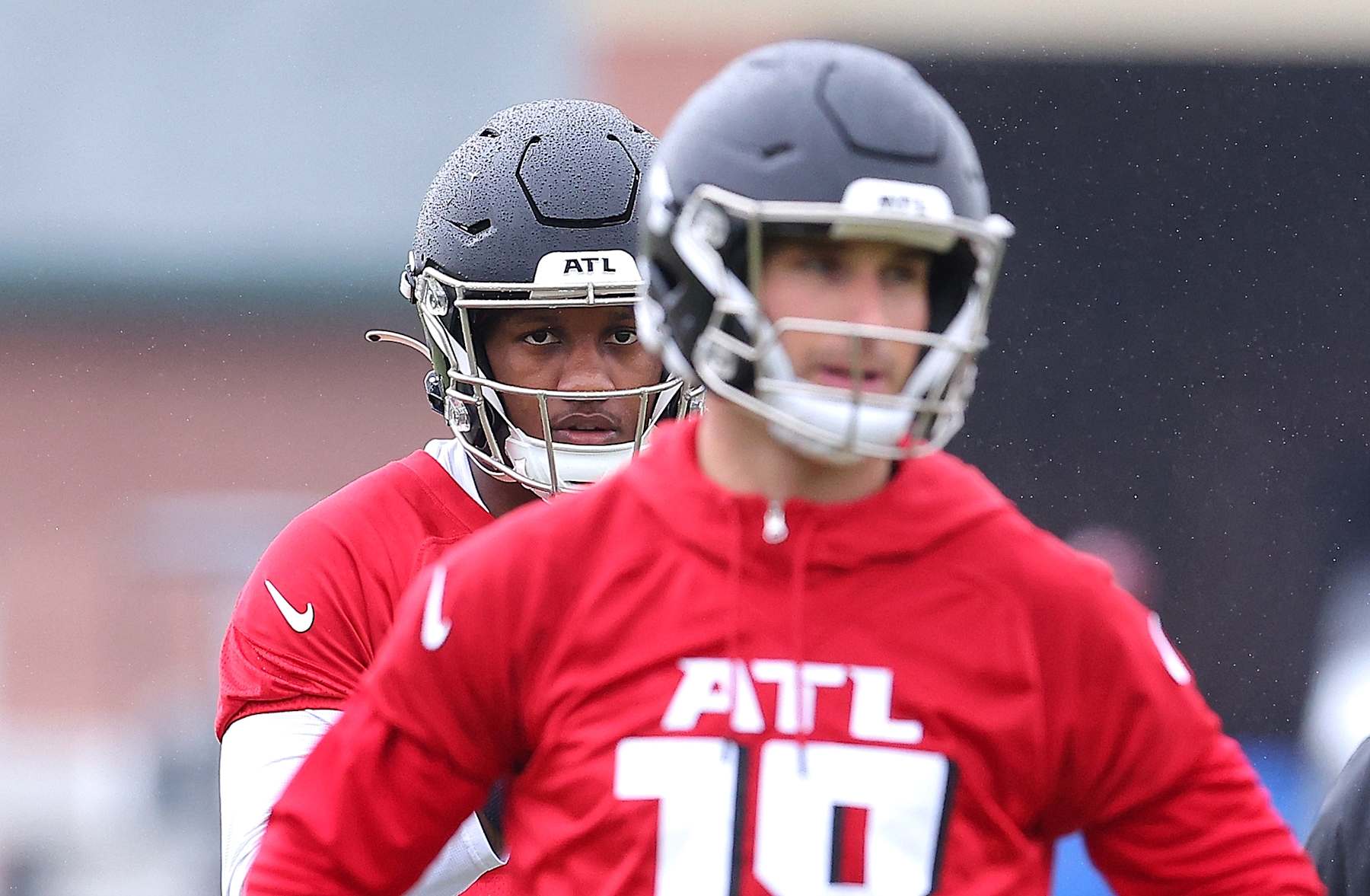 FLOWERY BRANCH, GEORGIA - MAY 14:  Quarterback Michael Penix Jr. #9 of the Atlanta Falcons looks on behind quarterback Kirk Cousins #18 during OTA offseason workouts at the Atlanta Falcons training facility on May 14, 2024 in Flowery Branch, Georgia. (Photo by Kevin C. Cox/Getty Images)
