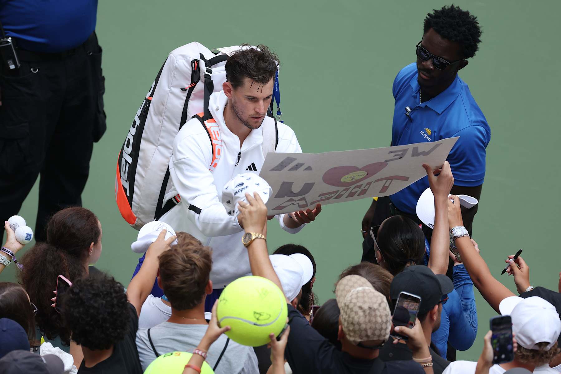 NEW YORK, NEW YORK - AUGUST 26: Dominic Thiem of Austria signs his autograph for fans after being defeated by Ben Shelton of the United States in their Men's Singles First Round match on Day One of the 2024 US Open at the USTA Billie Jean King National Tennis Center on August 26, 2024 in the Flushing neighborhood of the Queens borough of New York City. (Photo by Al Bello/Getty Images)