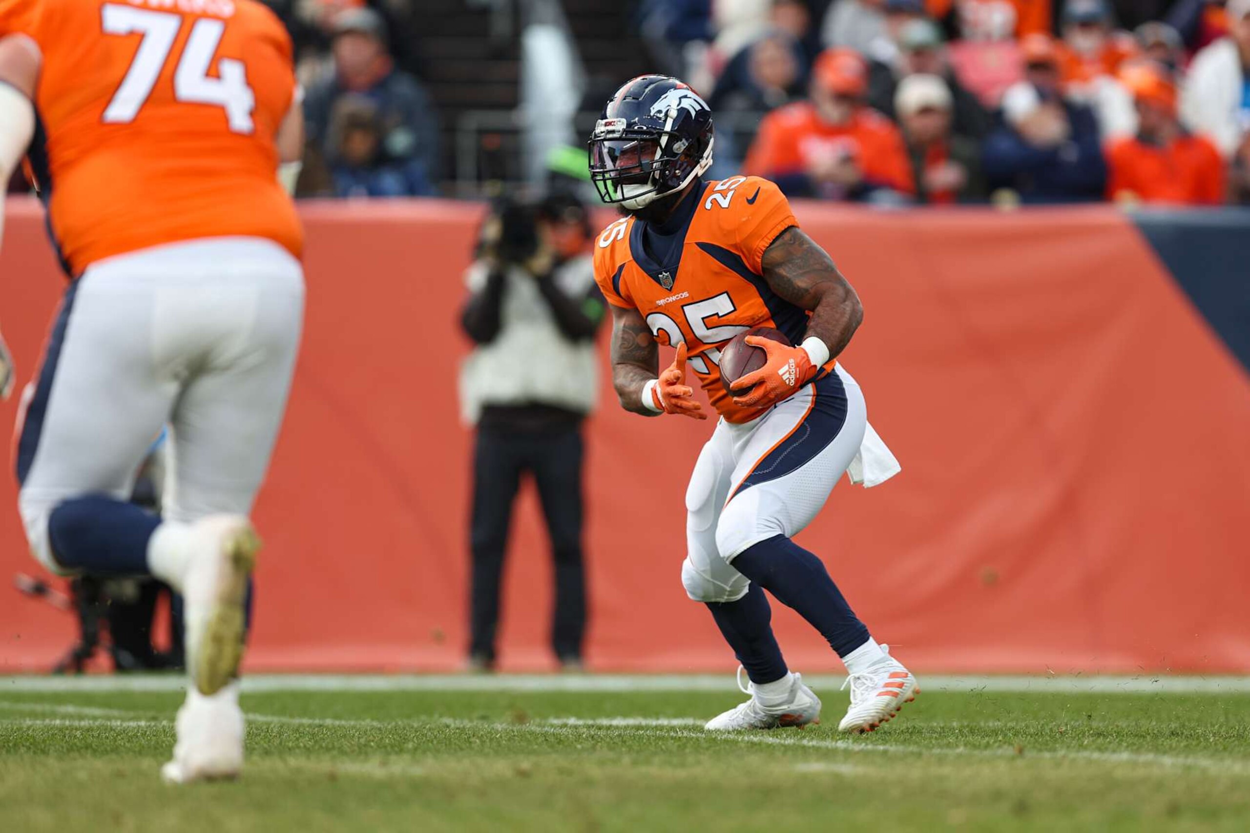 DENVER, CO - DECEMBER 31: Samaje Perine #25 of the Denver Broncos runs the ball during an NFL football game against the Los Angeles Chargers at Empower Field at Mile High on December 31, 2023 in Denver, Colorado. (Photo by Perry Knotts/Getty Images)