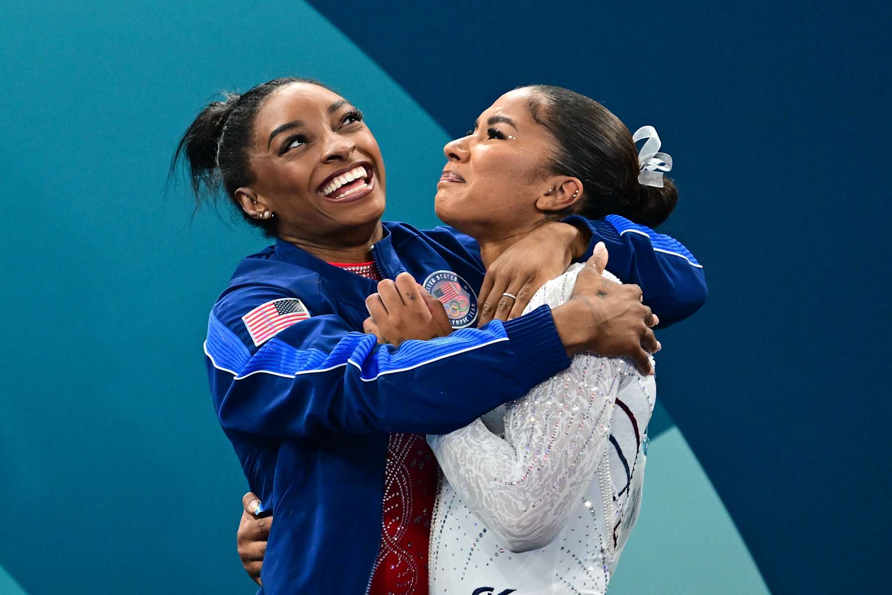 PARIS, FRANCE: AUGUST 05: Jordan Chiles of the United States is congratulated by teammate Simone Biles (L) of the United States after dramatically claiming the bronze medal on a score change after the Women's Floor Final during the Artistic Gymnastics competition at the Bercy Arena during the Paris 2024 Summer Olympic Games on August 5th, 2024 in Paris, France. (Photo by Mehmet Murat Onel/Anadolu via Getty Images)