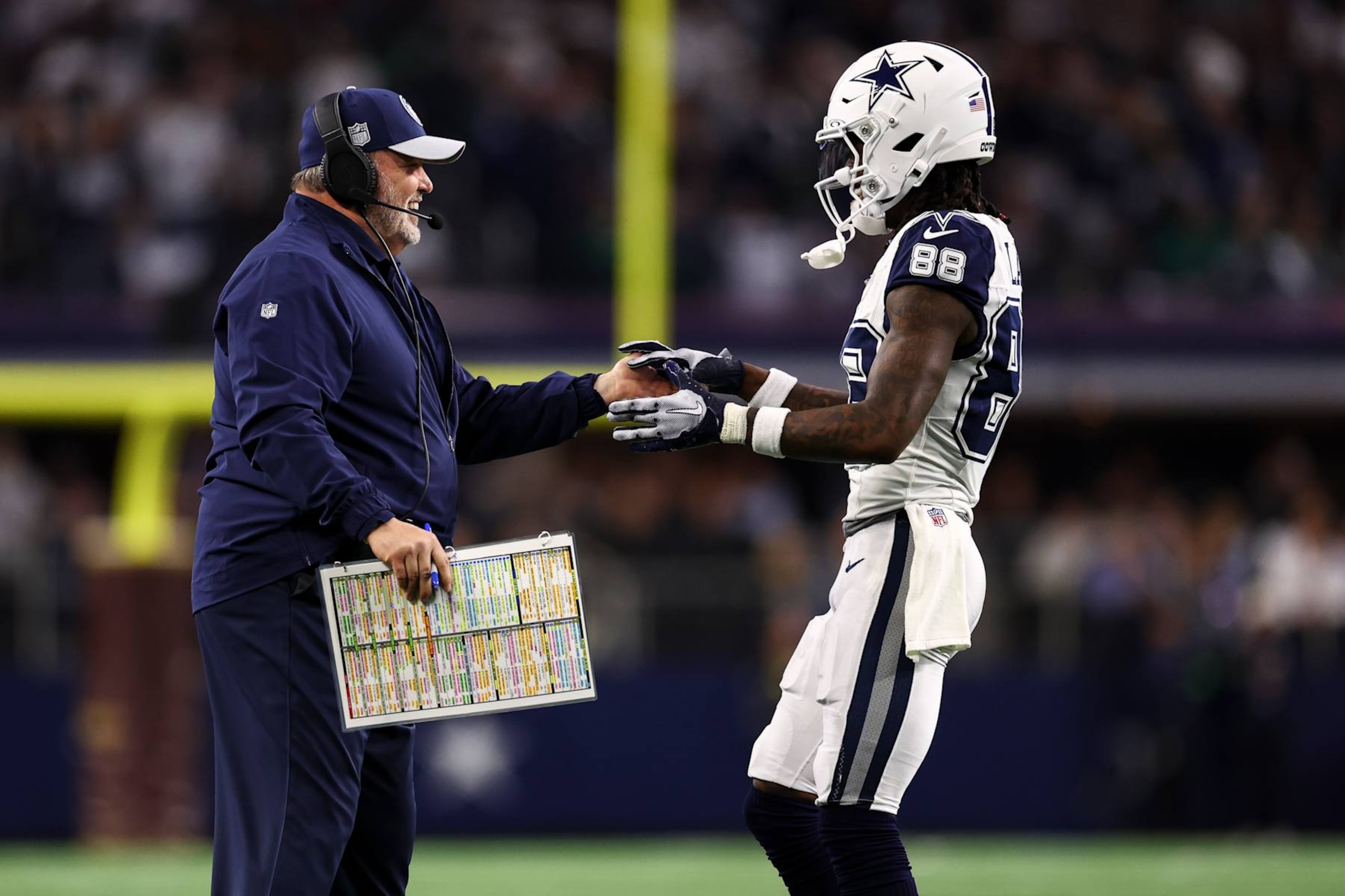 ARLINGTON, TX - DECEMBER 10: Head coach Mike McCarthy of the Dallas Cowboys high fives CeeDee Lamb #88 during an NFL football game against the Philadelphia Eagles at AT&T Stadium on December 10, 2023 in Arlington, Texas. (Photo by Kevin Sabitus/Getty Images) ARLINGTON, TX - DECEMBER 10: Head coach Mike McCarthy of the Dallas Cowboys high fives CeeDee Lamb #88 during an NFL football game against the Philadelphia Eagles at AT&T Stadium on December 10, 2023 in Arlington, Texas. (Photo by Kevin Sabitus/Getty Images)