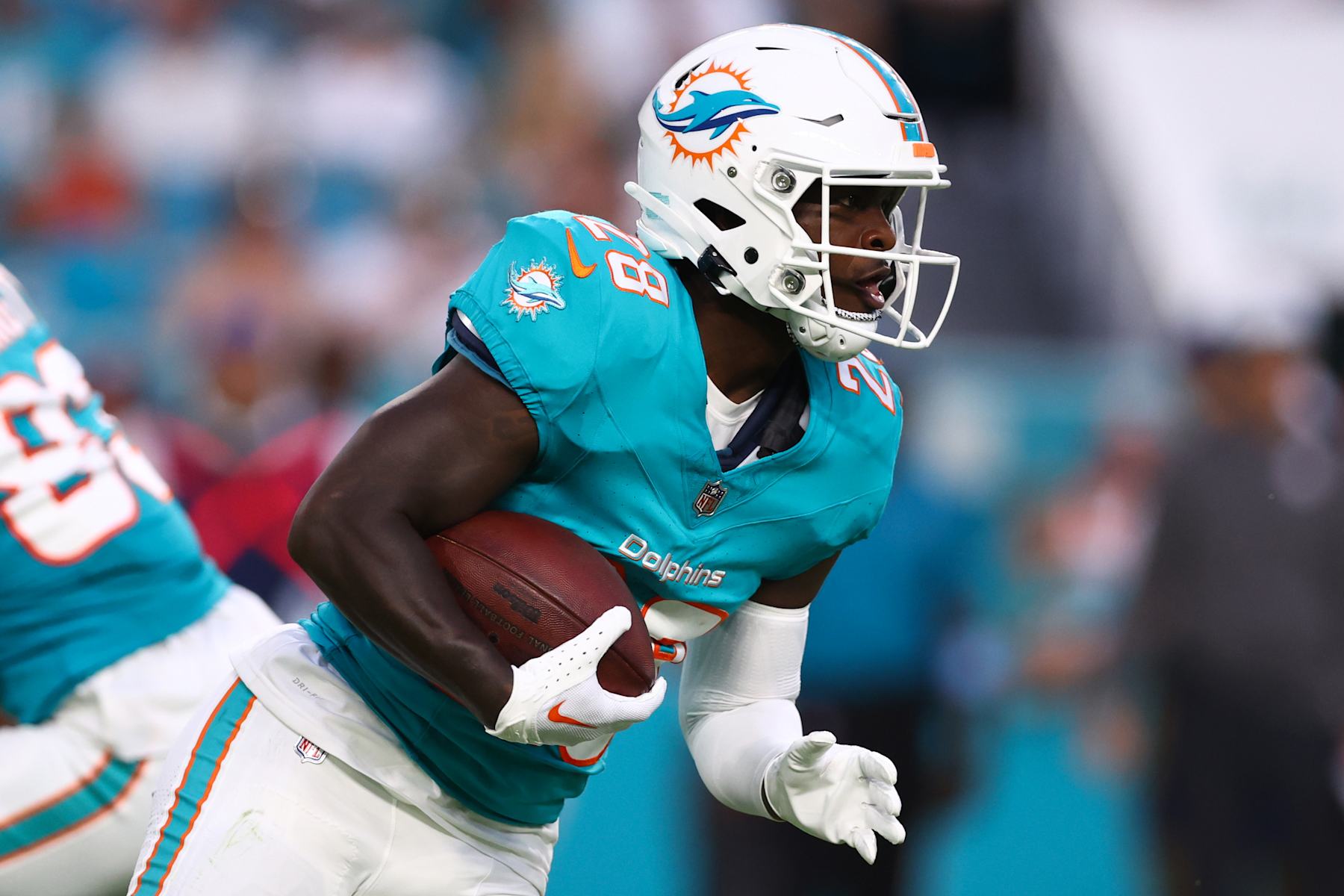 MIAMI GARDENS, FLORIDA - AUGUST 17: De'Von Achane #28 of the Miami Dolphins carries the ball against the Washington Commanders during the first quarter of a preseason game at Hard Rock Stadium on August 17, 2024 in Miami Gardens, Florida. (Photo by Megan Briggs/Getty Images)