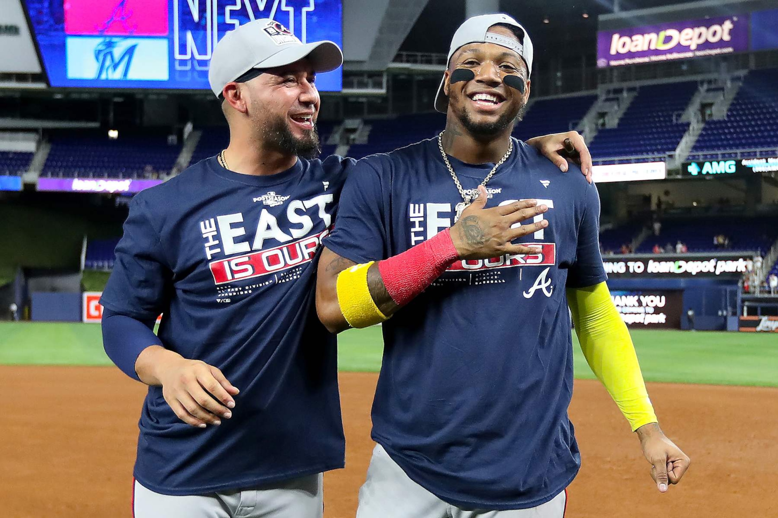 MIAMI, FLORIDA - OCTOBER 04: Ronald Acuna Jr. #13 of the Atlanta Braves (R) celebrates on the field after clinching the division against the Miami Marlins at loanDepot park on October 04, 2022 in Miami, Florida. (Photo by Megan Briggs/Getty Images) MIAMI, FLORIDA - OCTOBER 04: Ronald Acuna Jr. #13 of the Atlanta Braves (R) celebrates on the field after clinching the division against the Miami Marlins at loanDepot park on October 04, 2022 in Miami, Florida. (Photo by Megan Briggs/Getty Images)