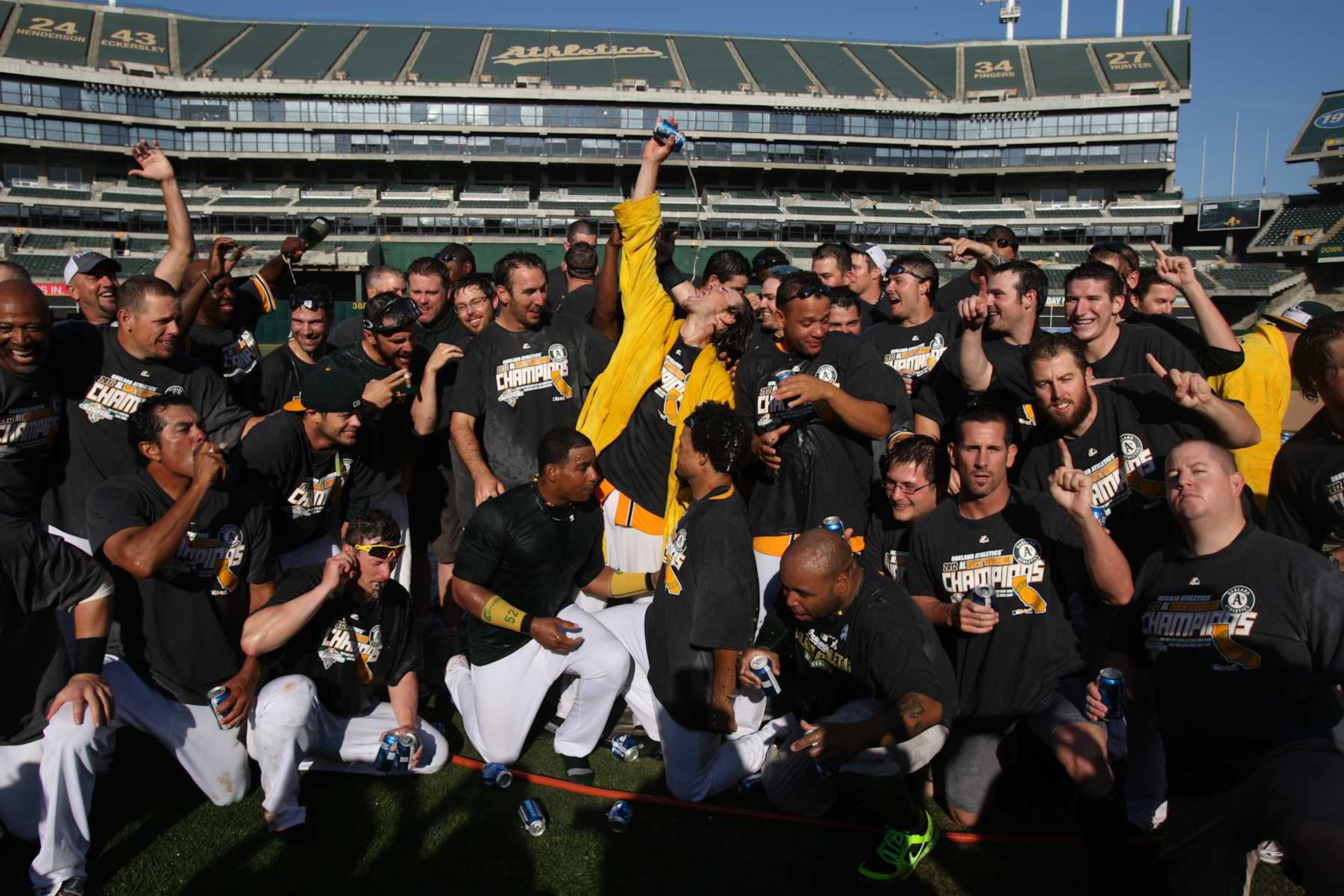 OAKLAND, CA - OCTOBER 3: Members of the Oakland Athletics celebrate and pose for photos on the pitchers mound after defeating the Texas Rangers to clinch the AL West Division title on Wednesday, October 3, 2012 at The Coliseum in Oakland, California. (Photo by Brad Mangin/MLB via Getty Images) OAKLAND, CA - OCTOBER 3: Members of the Oakland Athletics celebrate and pose for photos on the pitchers mound after defeating the Texas Rangers to clinch the AL West Division title on Wednesday, October 3, 2012 at The Coliseum in Oakland, California. (Photo by Brad Mangin/MLB via Getty Images)