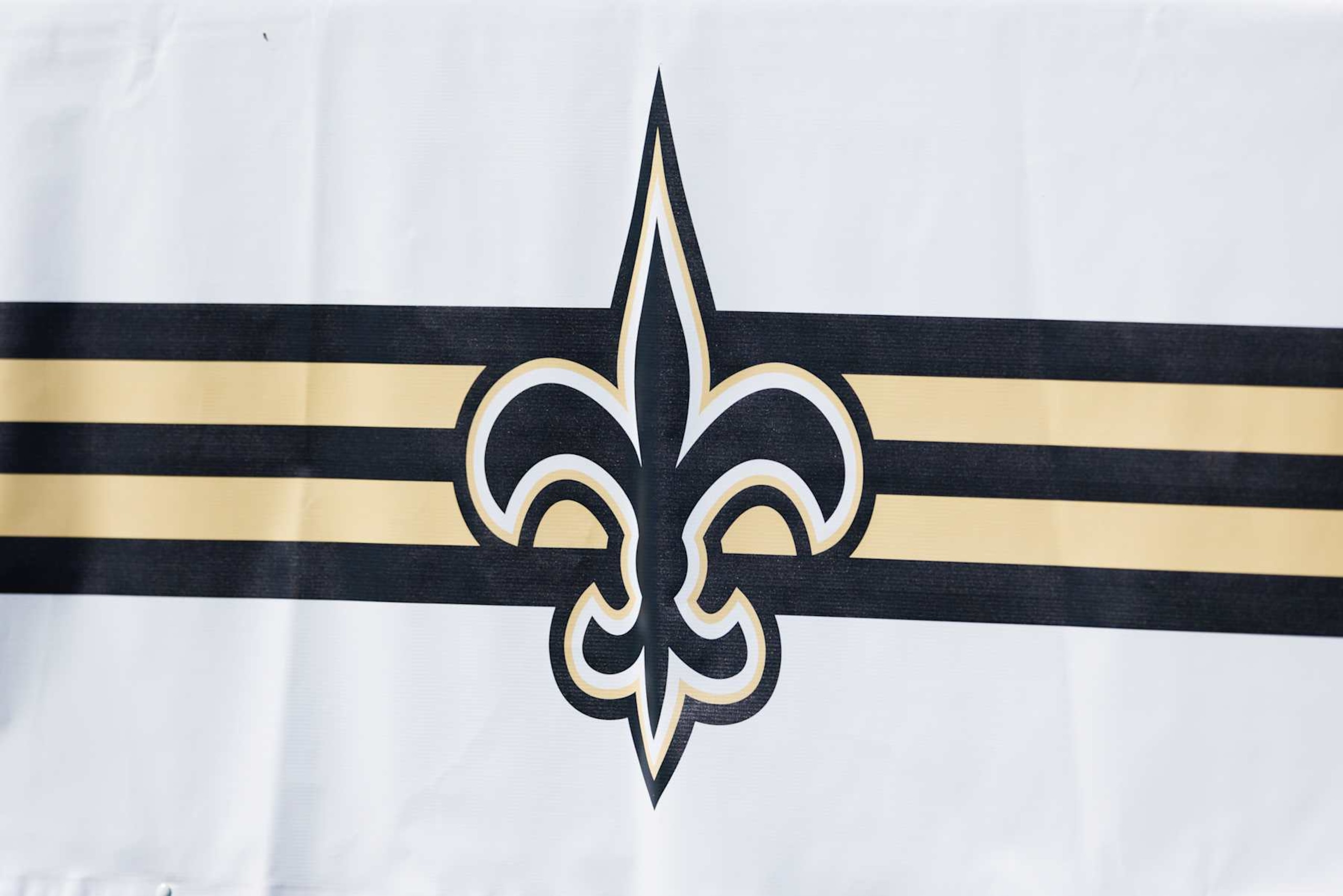 IRVINE, CALIFORNIA - JULY 29: A detail view of a New Orleans Saints logo on a sign during training camp at University of California Irvine on July 29, 2024 in Irvine, California. (Photo by Ric Tapia/Getty Images) IRVINE, CALIFORNIA - JULY 29: A detail view of a New Orleans Saints logo on a sign during training camp at University of California Irvine on July 29, 2024 in Irvine, California. (Photo by Ric Tapia/Getty Images)