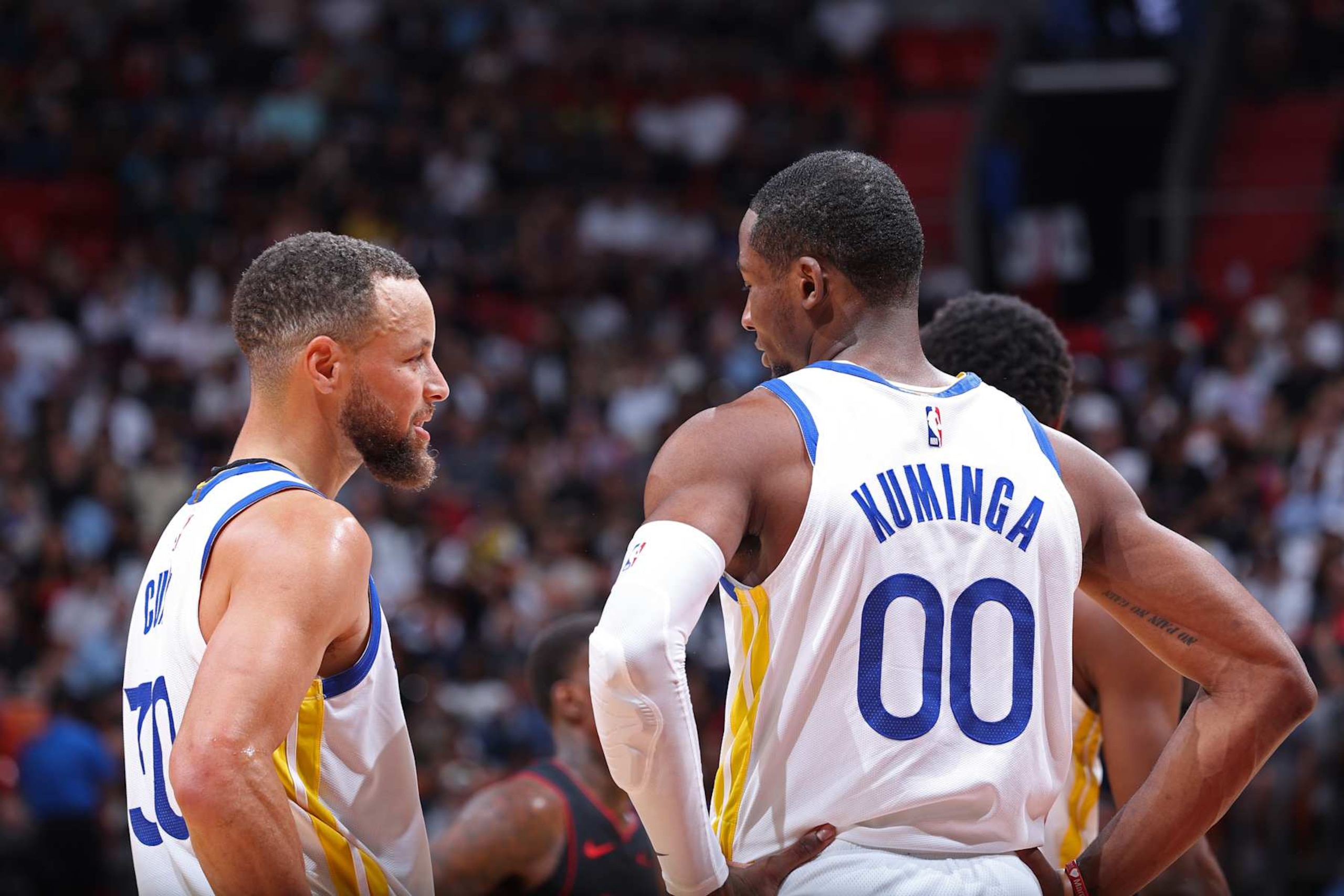 MIAMI, FL - MARCH 26: Stephen Curry #30 and Jonathan Kuminga #00 of the Golden State Warriors looks on during the game against the Miami Heat on March 26, 2024 at Kaseya Center in Miami, Florida. NOTE TO USER: User expressly acknowledges and agrees that, by downloading and or using this Photograph, user is consenting to the terms and conditions of the Getty Images License Agreement. Mandatory Copyright Notice: Copyright 2024 NBAE (Photo by Jeff Haynes/NBAE via Getty Images)