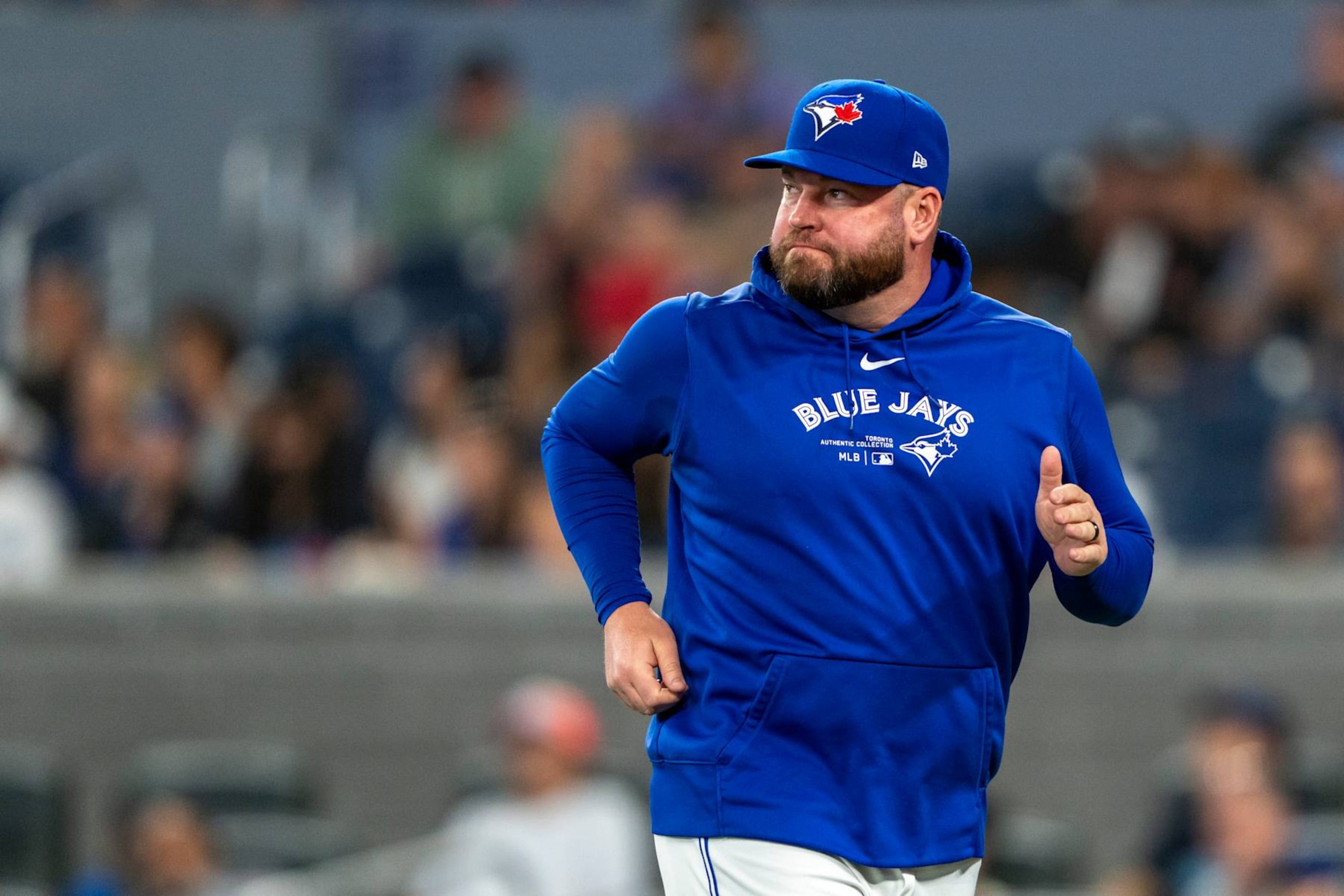 TORONTO, CANADA - AUGUST 11: John Schneider #14 of the Toronto Blue Jays returns to the dugout during the seventh inning in their MLB game against the Oakland Athletics at Rogers Centre on August 11, 2024 in Toronto, Canada. (Photo by Kevin Sousa/Getty Images)