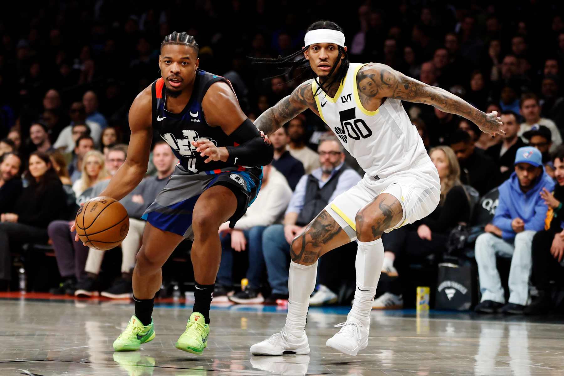 NEW YORK, NEW YORK - JANUARY 29: Dennis Smith Jr. #4 of the Brooklyn Nets dribbles against Jordan Clarkson #00 of the Utah Jazz during the second half at Barclays Center on January 29, 2024 in the Brooklyn borough of New York City. The Nets won 147-114. NOTE TO USER: User expressly acknowledges and agrees that, by downloading and/or using this Photograph, user is consenting to the terms and conditions of the Getty Images License Agreement. (Photo by Sarah Stier/Getty Images)