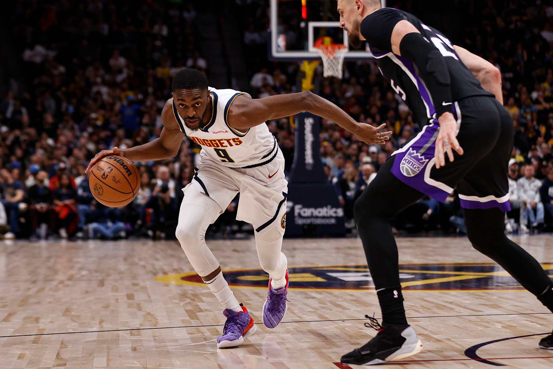 DENVER, COLORADO - FEBRUARY 28: Justin Holiday #9 of the Denver Nuggets dribbles the ball during the fourth quarter of the game against the Sacramento Kings at Ball Arena on February 28, 2024 in Denver, Colorado. NOTE TO USER: User expressly acknowledges and agrees that, by downloading and or using this photograph, User is consenting to the terms and conditions of the Getty Images License Agreement. (Photo by Brendall O'Banon/Clarkson Creative/Getty Images)