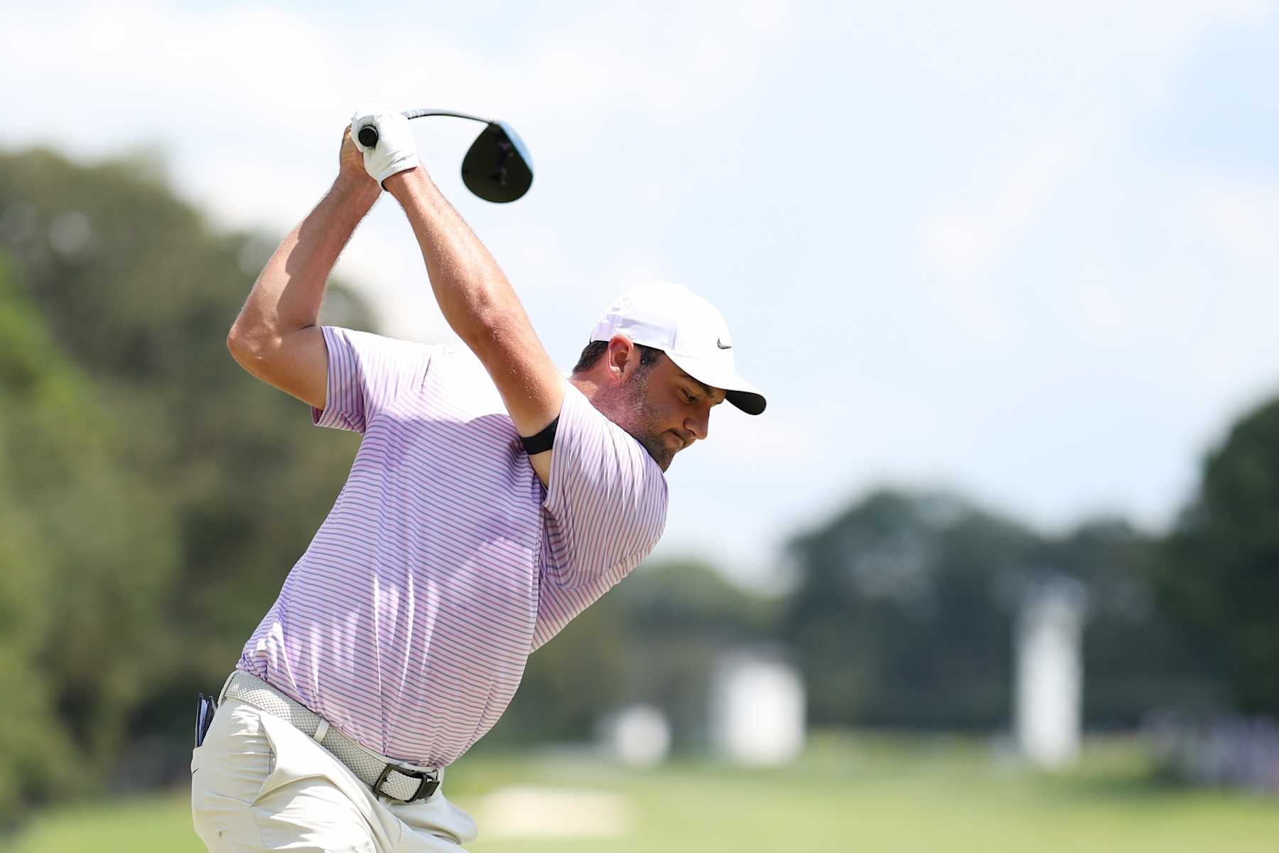 ATLANTA, GEORGIA - AUGUST 29: Scottie Scheffler of the United States hits his shot from the first tee during the first round of the TOUR Championship at East Lake Golf Club on August 29, 2024 in Atlanta, Georgia. (Photo by Mike Mulholland/Getty Images)