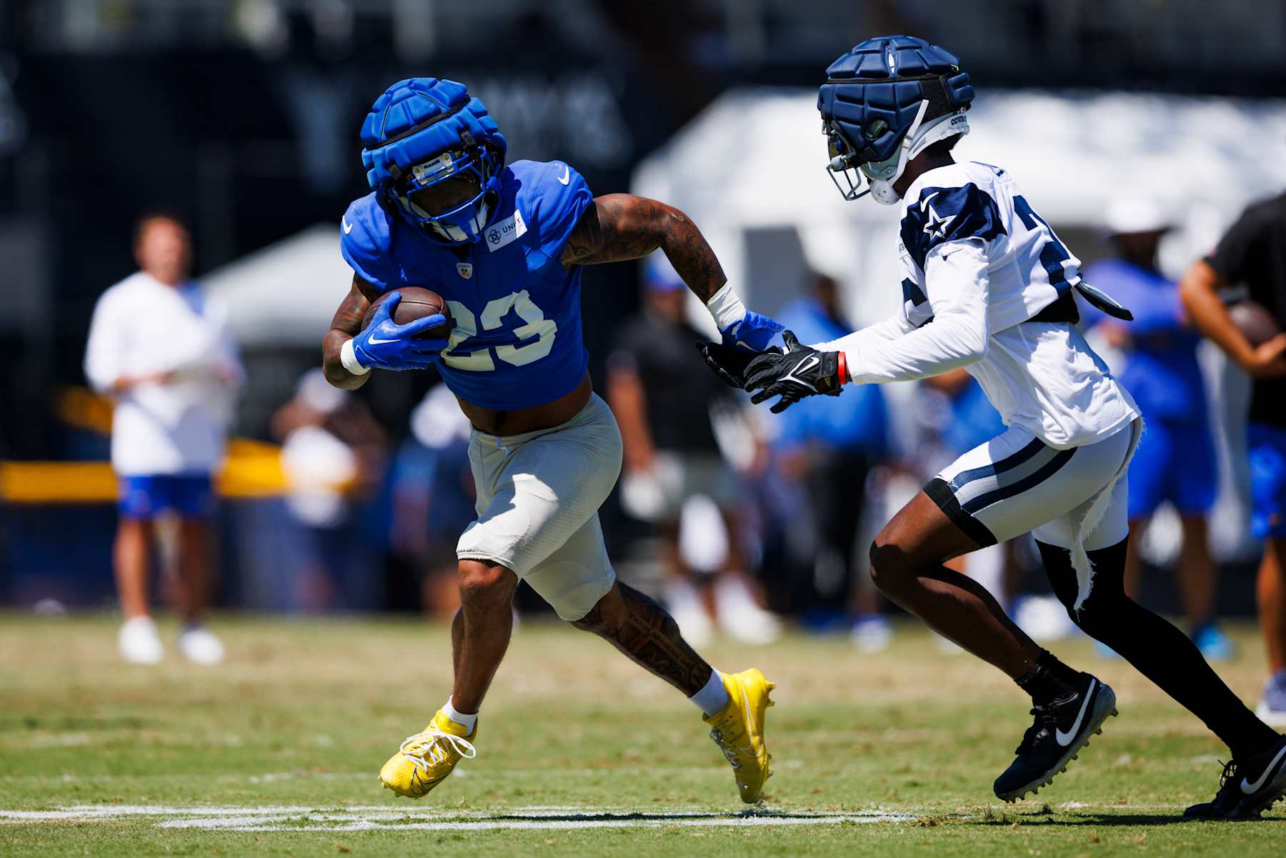 OXNARD, CALIFORNIA - AUGUST 14: Kyren Williams #23 of the Los Angeles Rams runs with the ball during a joint practice against the Dallas Cowboys at River Ridge Playing Fields on August 14, 2024 in Oxnard, California.  (Photo by Ric Tapia/Getty Images)
