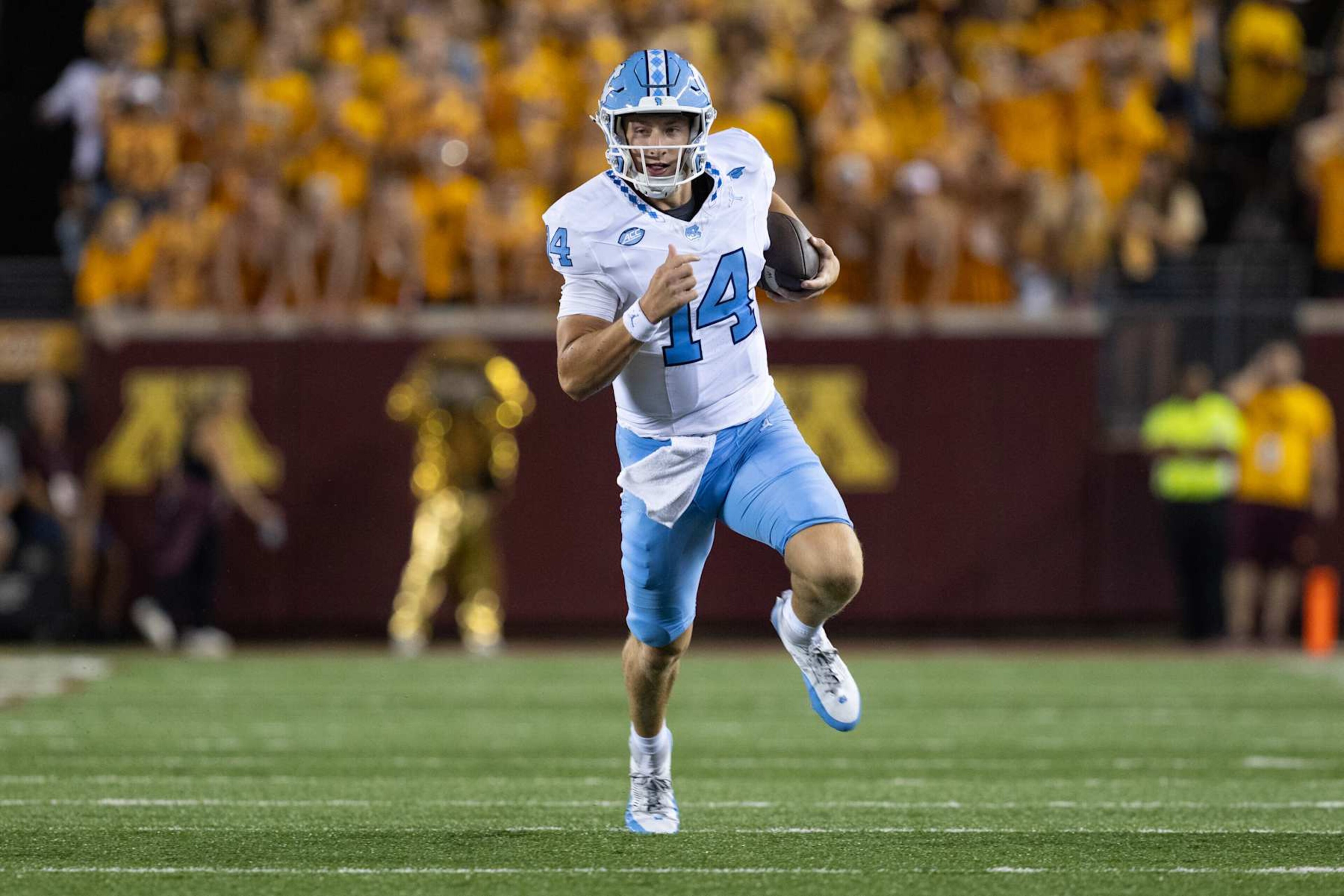 MINNEAPOLIS, MN - AUGUST 29: North Carolina Tar Heels quarterback Max Johnson (14) runs with the ball during the college football game between North Carolina Tar Heels and the Minnesota Golden Gophers on August 29, 2024, at Huntington Bank Stadium in Minneapolis, MN. (Photo by Bailey Hillesheim/Icon Sportswire via Getty Images) MINNEAPOLIS, MN - AUGUST 29: North Carolina Tar Heels quarterback Max Johnson (14) runs with the ball during the college football game between North Carolina Tar Heels and the Minnesota Golden Gophers on August 29, 2024, at Huntington Bank Stadium in Minneapolis, MN. (Photo by Bailey Hillesheim/Icon Sportswire via Getty Images)