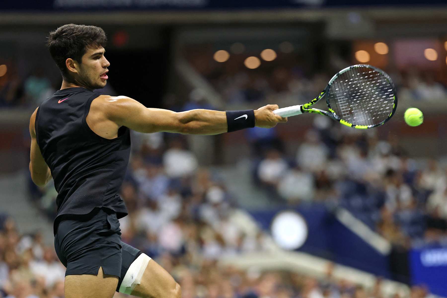 Spain's Carlos Alcaraz plays a forehand return against Netherlands' Botic van De Zandschulp during their men's singles second round tennis match on day four of the US Open tennis tournament at the USTA Billie Jean King National Tennis Center in New York City, on August 29, 2024. (Photo by CHARLY TRIBALLEAU / AFP) (Photo by CHARLY TRIBALLEAU/AFP via Getty Images)