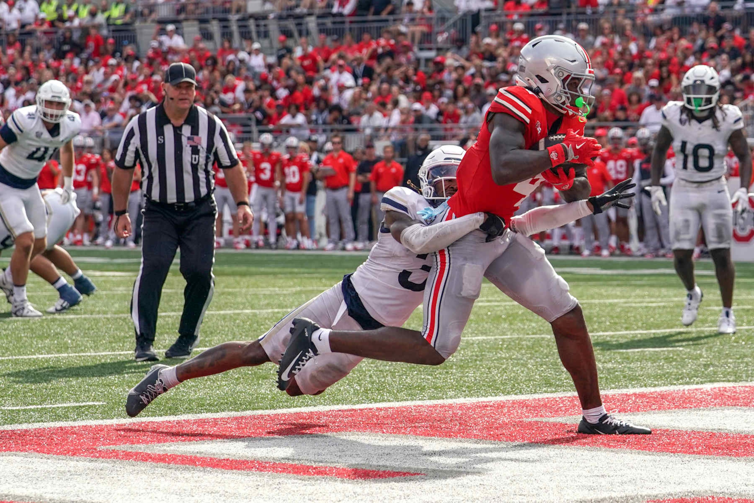 COLUMBUS, OHIO - AUGUST 31: Wide receiver Jeremiah Smith #4 of the Ohio State Buckeyes scores a touchdown  during the second quarter against the Akron Zips at Ohio Stadium on August 31, 2024 in Columbus, Ohio. (Photo by Jason Mowry/Getty Images)
