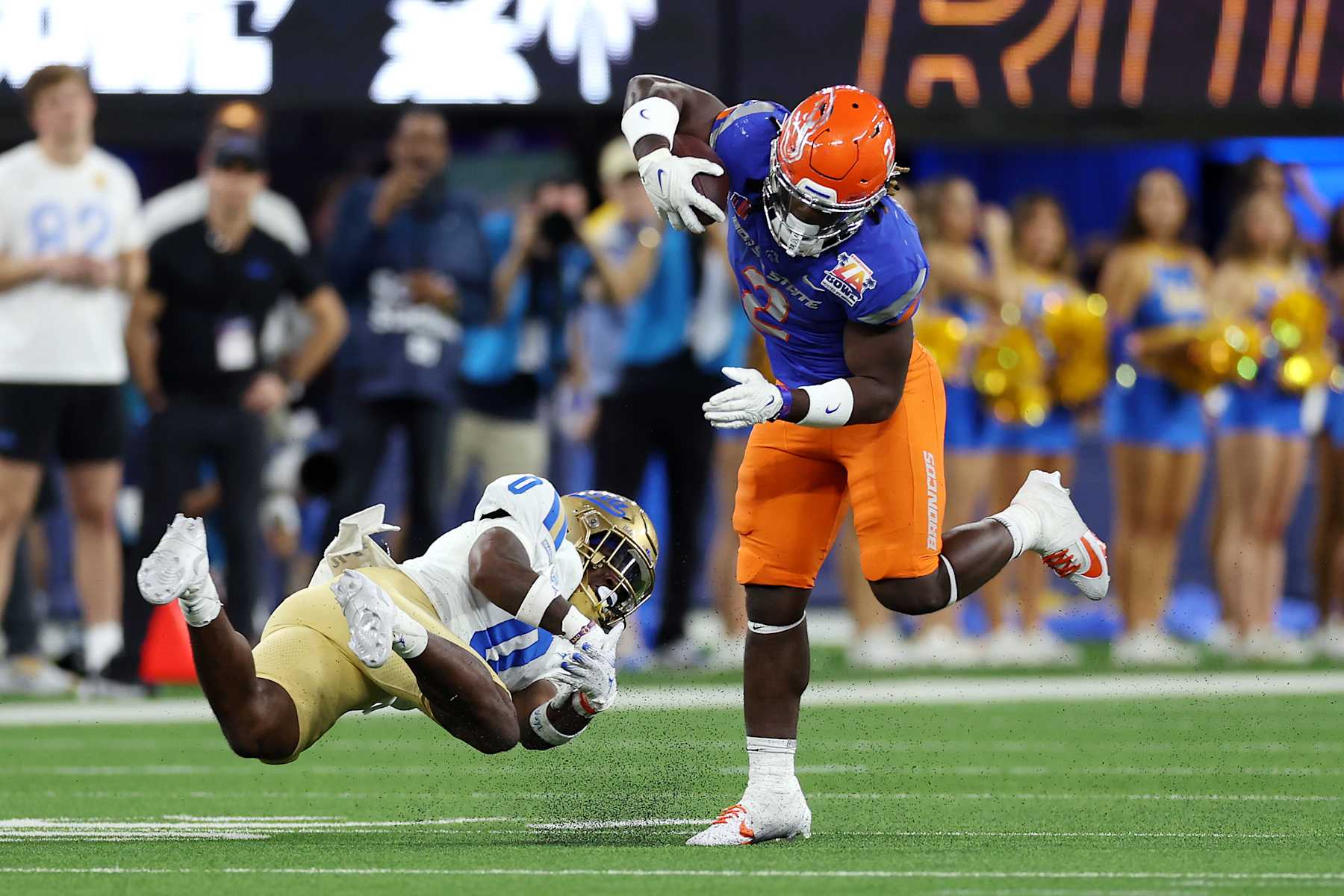 INGLEWOOD, CALIFORNIA - DECEMBER 16: Ashton Jeanty #2 of the Boise State Broncos avoids a tackle by Jordan Anderson #0 of the UCLA Bruins in the second quarter during the Starco Brands LA Bowl Hosted by Gronk at SoFi Stadium on December 16, 2023 in Inglewood, California. (Photo by Katelyn Mulcahy/Getty Images)