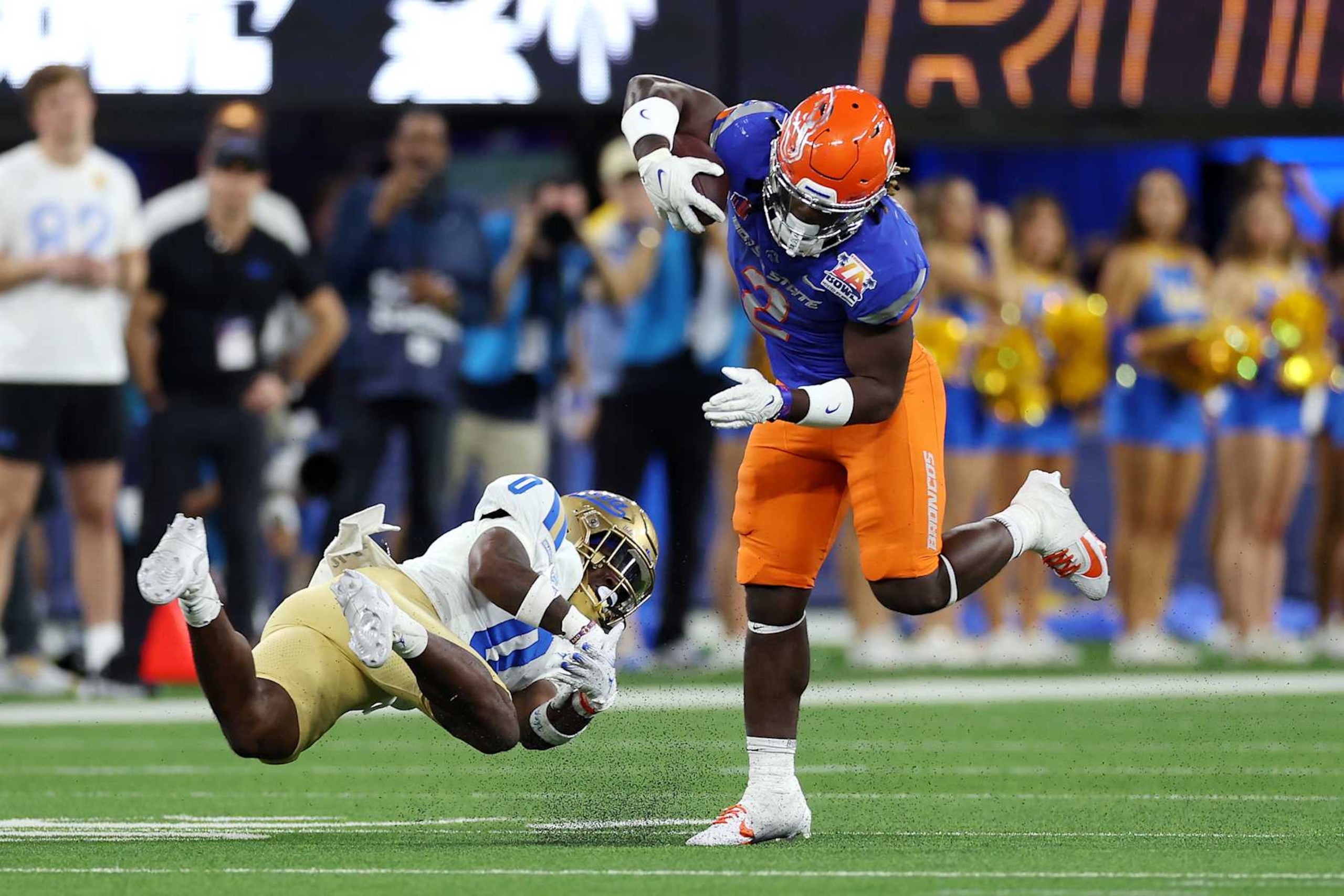 INGLEWOOD, CALIFORNIA - DECEMBER 16: Ashton Jeanty #2 of the Boise State Broncos avoids a tackle by Jordan Anderson #0 of the UCLA Bruins in the second quarter during the Starco Brands LA Bowl Hosted by Gronk at SoFi Stadium on December 16, 2023 in Inglewood, California. (Photo by Katelyn Mulcahy/Getty Images)