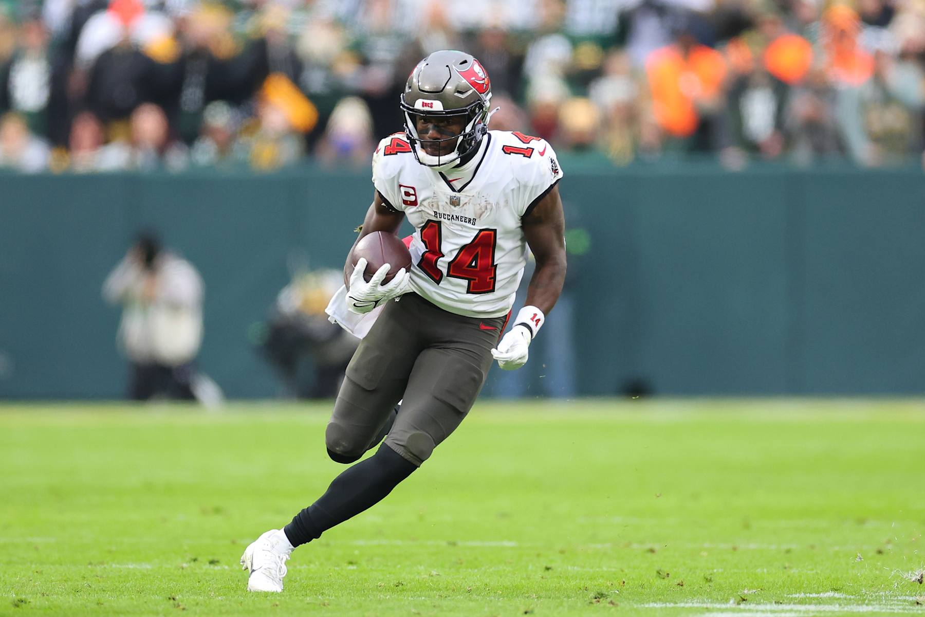 GREEN BAY, WISCONSIN - DECEMBER 17: Chris Godwin #14 of the Tampa Bay Buccaneers runs for yards during a game against the Green Bay Packers at Lambeau Field on December 17, 2023 in Green Bay, Wisconsin.  The Buccaneers defeated the Packers 34-20.   (Photo by Stacy Revere/Getty Images)