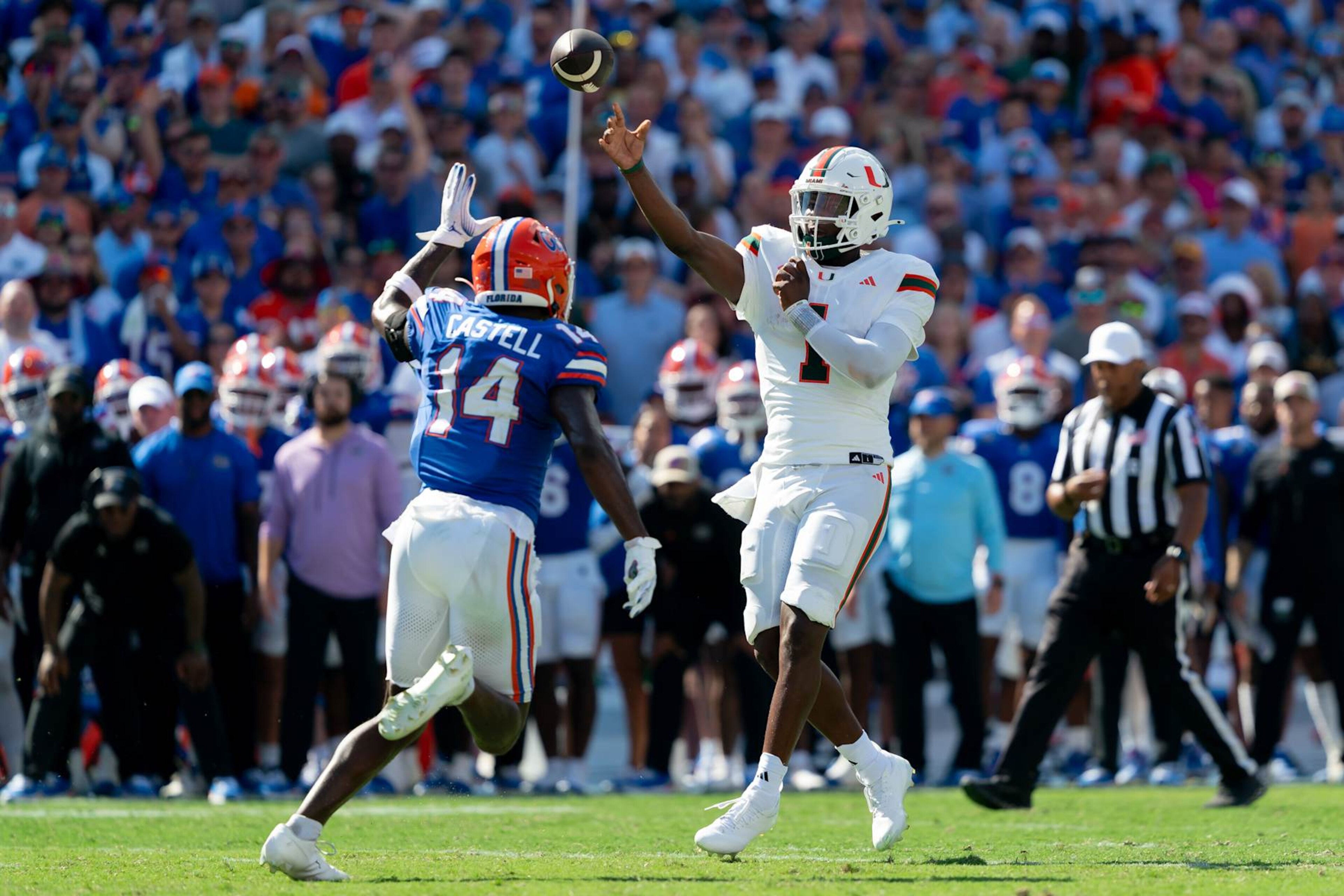 GAINESVILLE, FL - AUGUST 31:Miami Hurricanes quarterback Cam Ward (1) throws a pass as he's pressured by Florida Gators defensive back Jordan Castell (14) during a college football game between the Miami Hurricanes and the Florida Gators on August 17, 2024 at Ben Hill Griffin Stadium in Gainesville, FL. (Photo by Chris Leduc/Icon Sportswire via Getty Images) GAINESVILLE, FL - AUGUST 31:Miami Hurricanes quarterback Cam Ward (1) throws a pass as he's pressured by Florida Gators defensive back Jordan Castell (14) during a college football game between the Miami Hurricanes and the Florida Gators on August 17, 2024 at Ben Hill Griffin Stadium in Gainesville, FL. (Photo by Chris Leduc/Icon Sportswire via Getty Images)