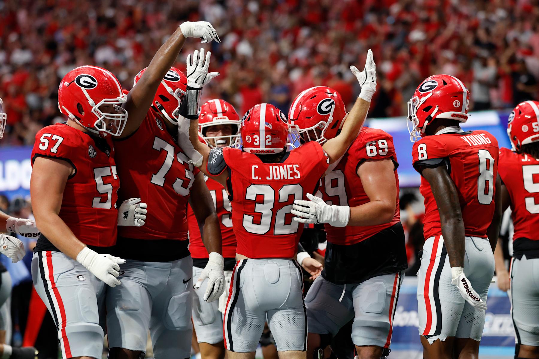 ATLANTA, GA - AUGUST 31: Georgia Bulldogs running back Cash Jones (32) celebrates with teammates after rushing for a 15-yard touchdown during the AFLAC Kickoff college football game against the Clemson Tigers on August 31, 2024 at Mercedes-Benz Stadium in Atlanta, Georgia. (Photo by Joe Robbins/Icon Sportswire via Getty Images)