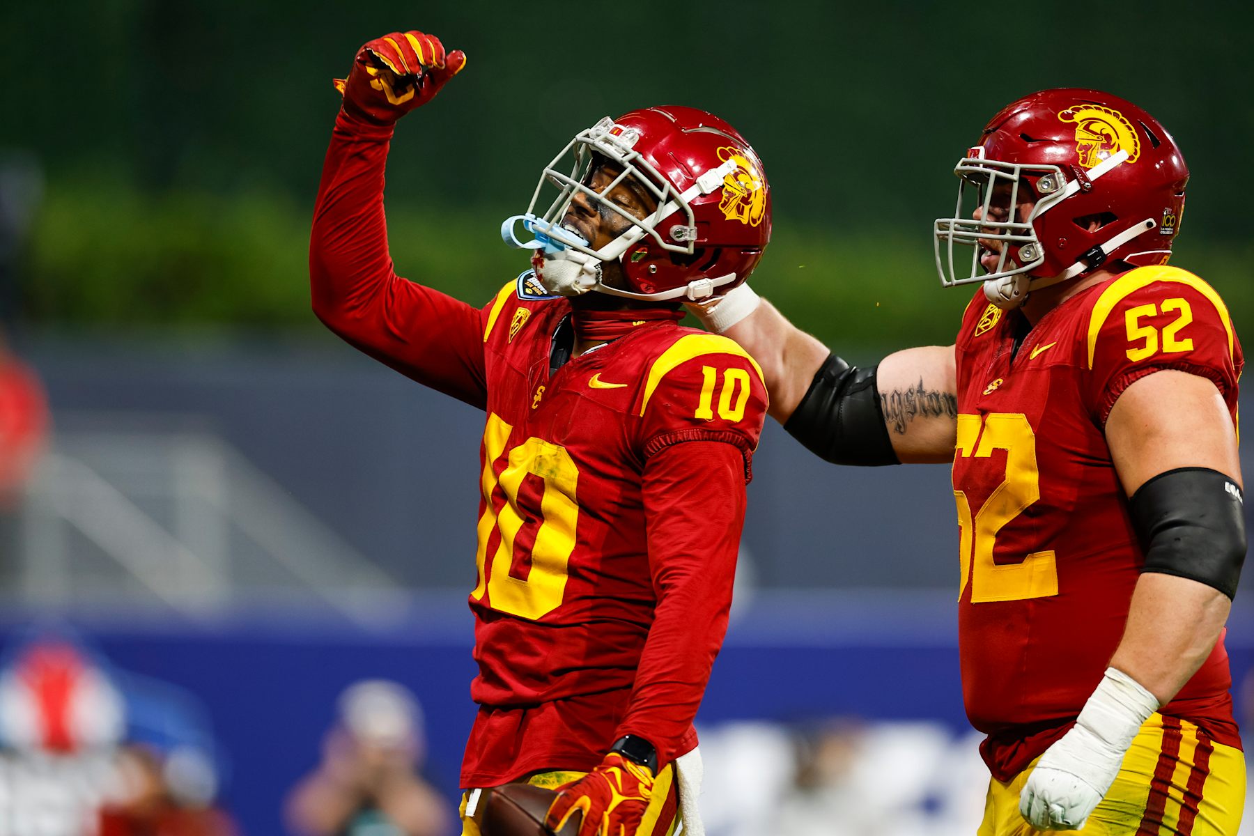 SAN DIEGO, CALIFORNIA - DECEMBER 27: Kyron Hudson #10 of the USC Trojans celebrates a touchdown catch in the second quarter during the DIRECTV Holiday Bowl game against the Louisville Cardinals at Petco Park on December 27, 2023 in San Diego, California. (Photo by Brandon Sloter/Getty Images)