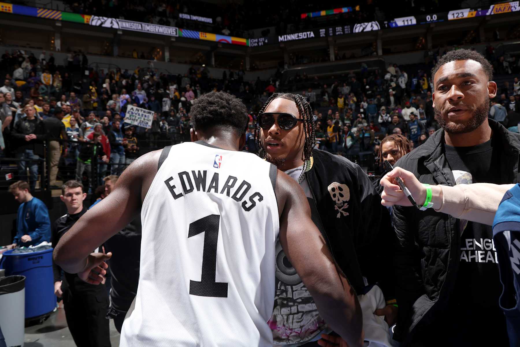 MINNEAPOLIS, MN -  MARCH 31: Anthony Edwards #1 of the Minnesota Timberwolves hugs Justin Jefferson after the game on March 31, 2023 at Target Center in Minneapolis, Minnesota. NOTE TO USER: User expressly acknowledges and agrees that, by downloading and or using this Photograph, user is consenting to the terms and conditions of the Getty Images License Agreement. Mandatory Copyright Notice: Copyright 2023 NBAE (Photo by David Sherman/NBAE via Getty Images)