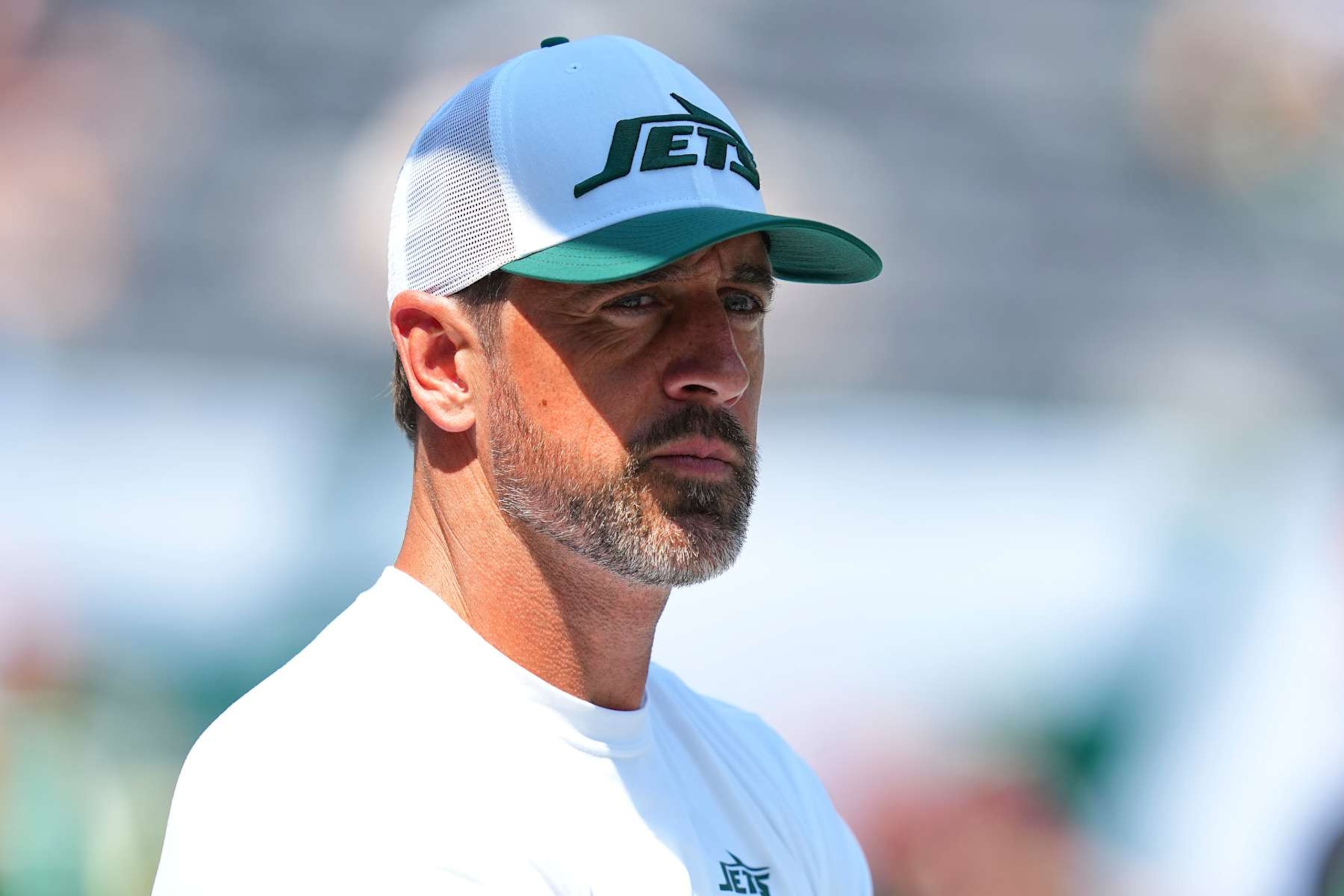 EAST RUTHERFORD, NEW JERSEY - AUGUST 10: Aaron Rodgers #8 of the New York Jets looks on against the Washington Commanders during the preseason game at MetLife Stadium on August 10, 2024 in East Rutherford, New Jersey. The Jets defeated the Commanders 20-17. (Photo by Mitchell Leff/Getty Images)
