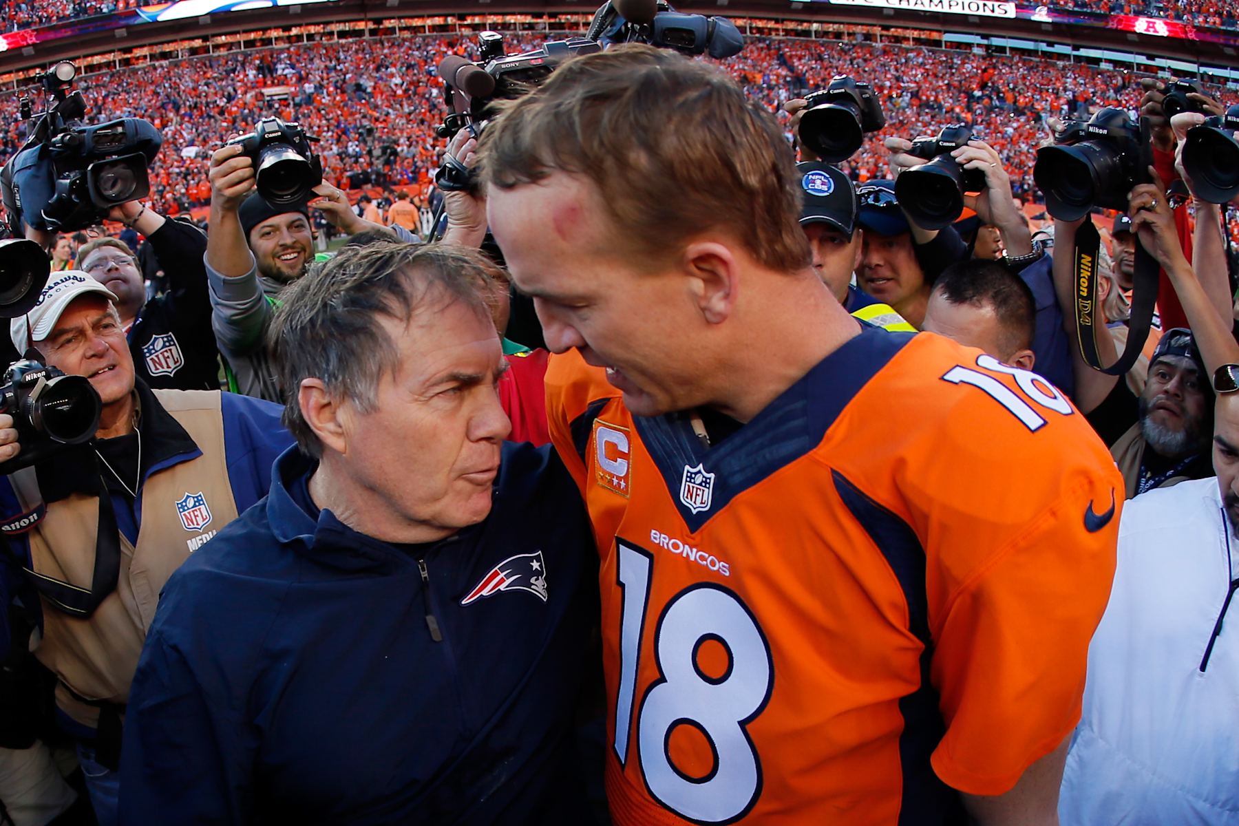 DENVER, CO - JANUARY 19:  Head coach Bill Belichick of the New England Patriots congratulates  Peyton Manning #18 of the Denver Broncos after the Broncos defeated the New England Patriots 26 to 16 during the AFC Championship game at Sports Authority Field at Mile High on January 19, 2014 in Denver, Colorado.  (Photo by Kevin C. Cox/Getty Images) 