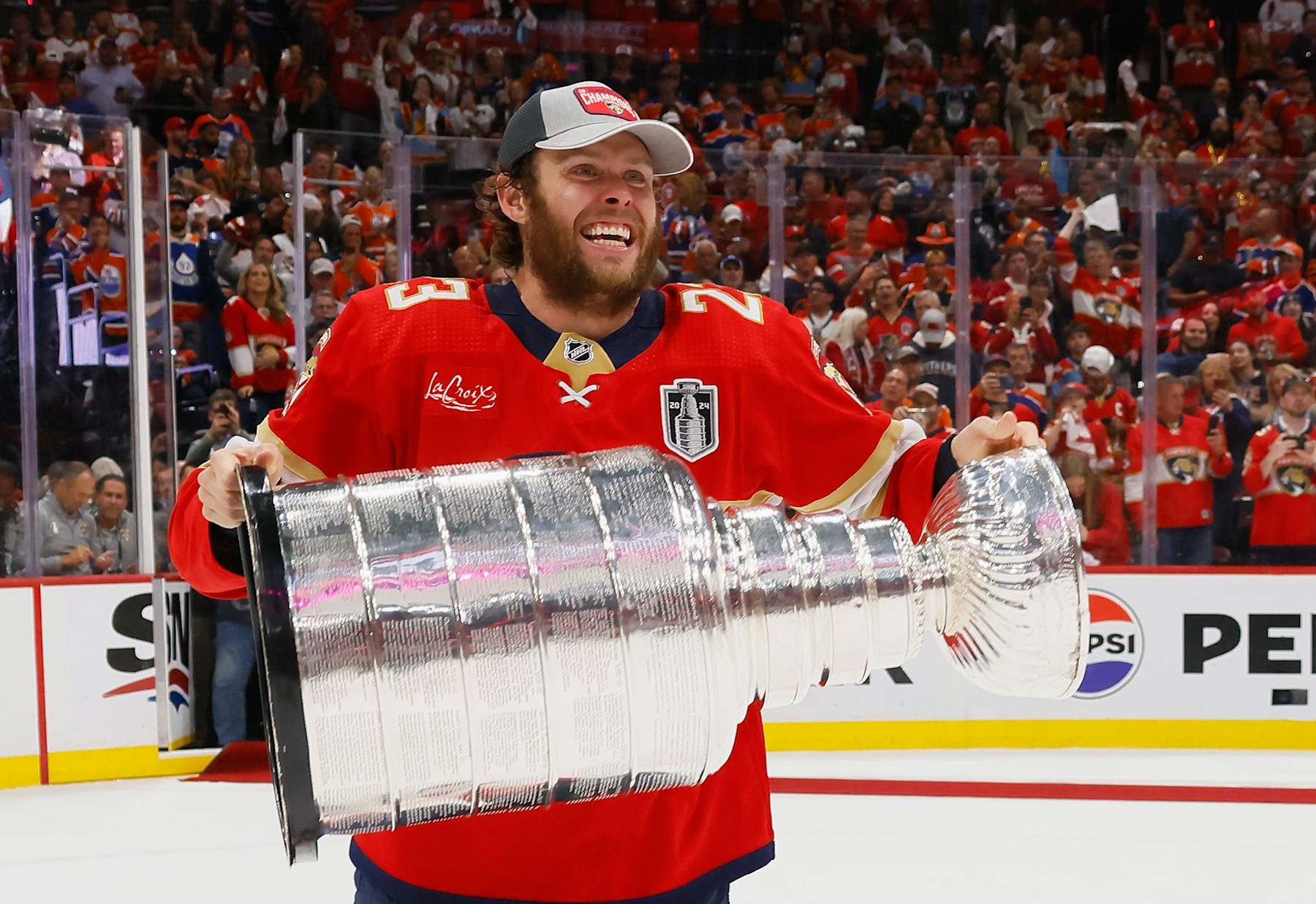 SUNRISE, FLORIDA - JUNE 24: Carter Verhaeghe #23 of the Florida Panthers celebrates with the Stanley Cup following a 2-1 victory over the Edmonton Oilers in Game Seven of the 2024 NHL Stanley Cup Final at Amerant Bank Arena on June 24, 2024 in Sunrise, Florida. (Photo by Bruce Bennett/Getty Images)