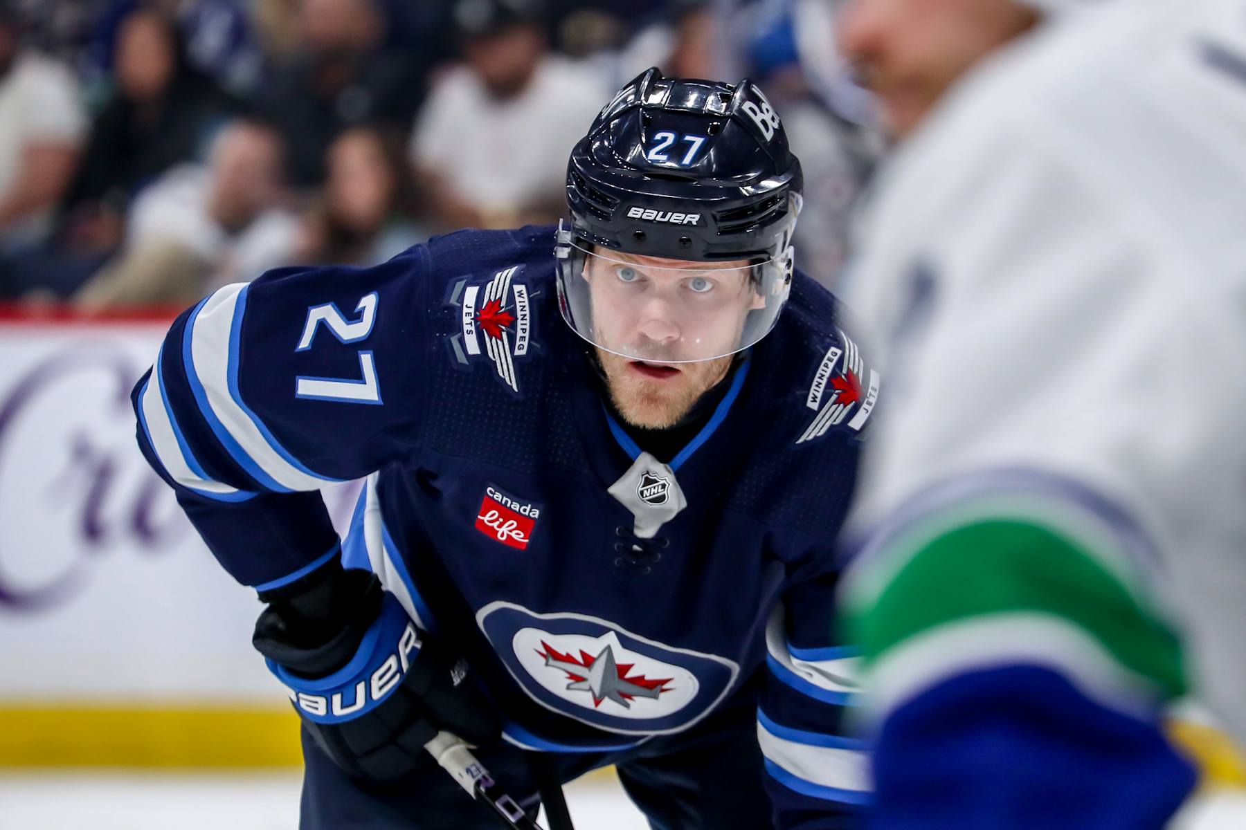 WINNIPEG, CANADA - APRIL 18: Nikolaj Ehlers #27 of the Winnipeg Jets looks on during a third period face-off against the Vancouver Canucks at the Canada Life Centre on April 18, 2024 in Winnipeg, Manitoba, Canada. The Jets defeated the Canucks 4-2. (Photo by Darcy Finley/NHLI via Getty Images)