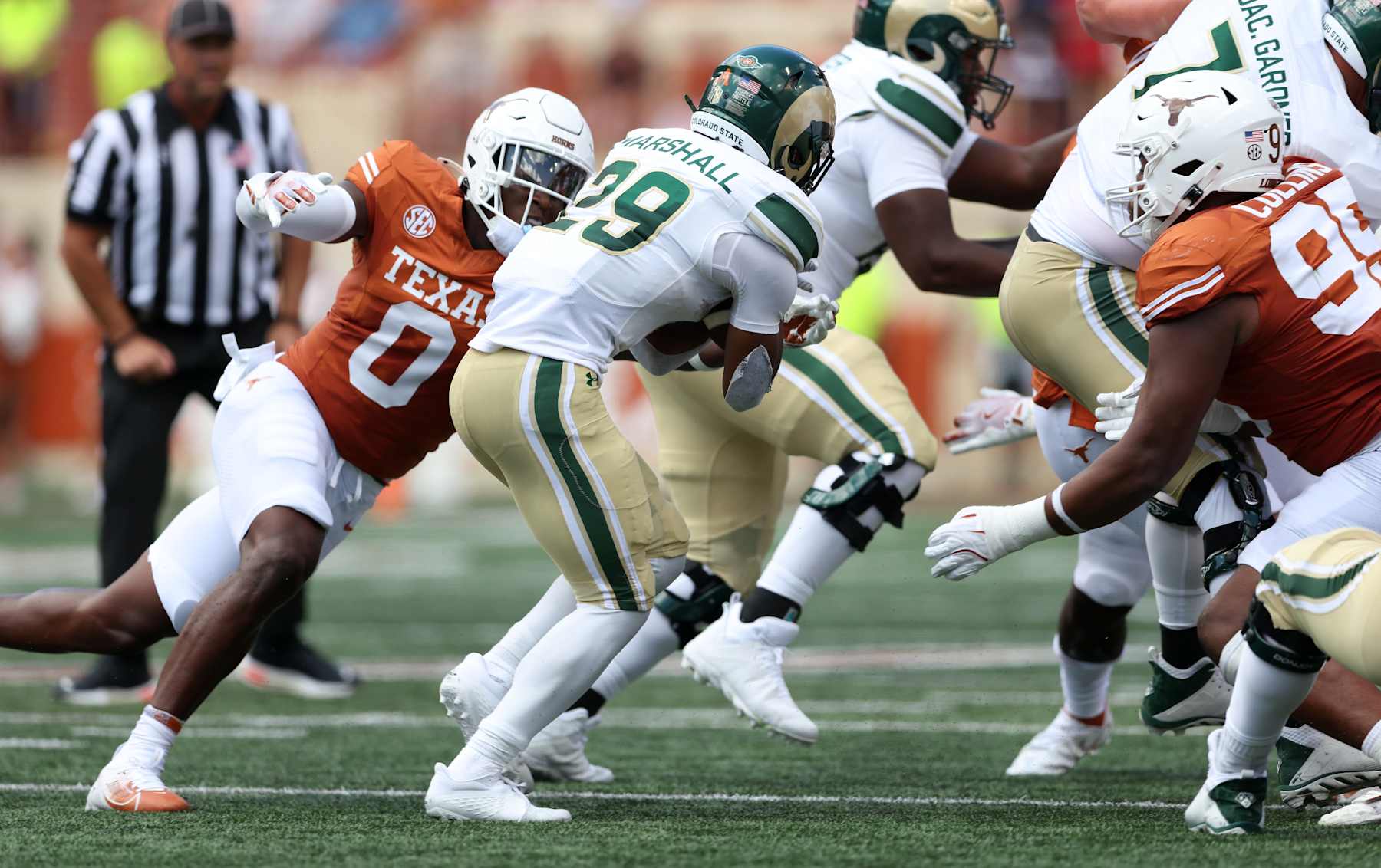 AUSTIN, TEXAS - AUGUST 31: Justin Marshall #29 of the Colorado State Rams runs the ball while defended by Anthony Hill Jr. #0 of the Texas Longhorns and Alfred Collins #95 in the first quarter at Darrell K Royal-Texas Memorial Stadium on August 31, 2024 in Austin, Texas. (Photo by Tim Warner/Getty Images)