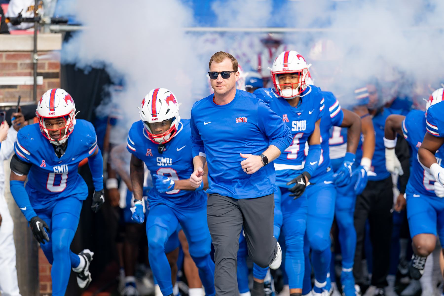 DALLAS, TX - NOVEMBER 25: Southern Methodist Mustangs head coach Rhett Lashlee leads the team out of the tunnel before a college football game between the Navy Midshipmen and Southern Methodist Mustangs on November 25, 2023 at Gerald Ford Stadium in Dallas, TX.  (Photo by Chris Leduc/Icon Sportswire via Getty Images)