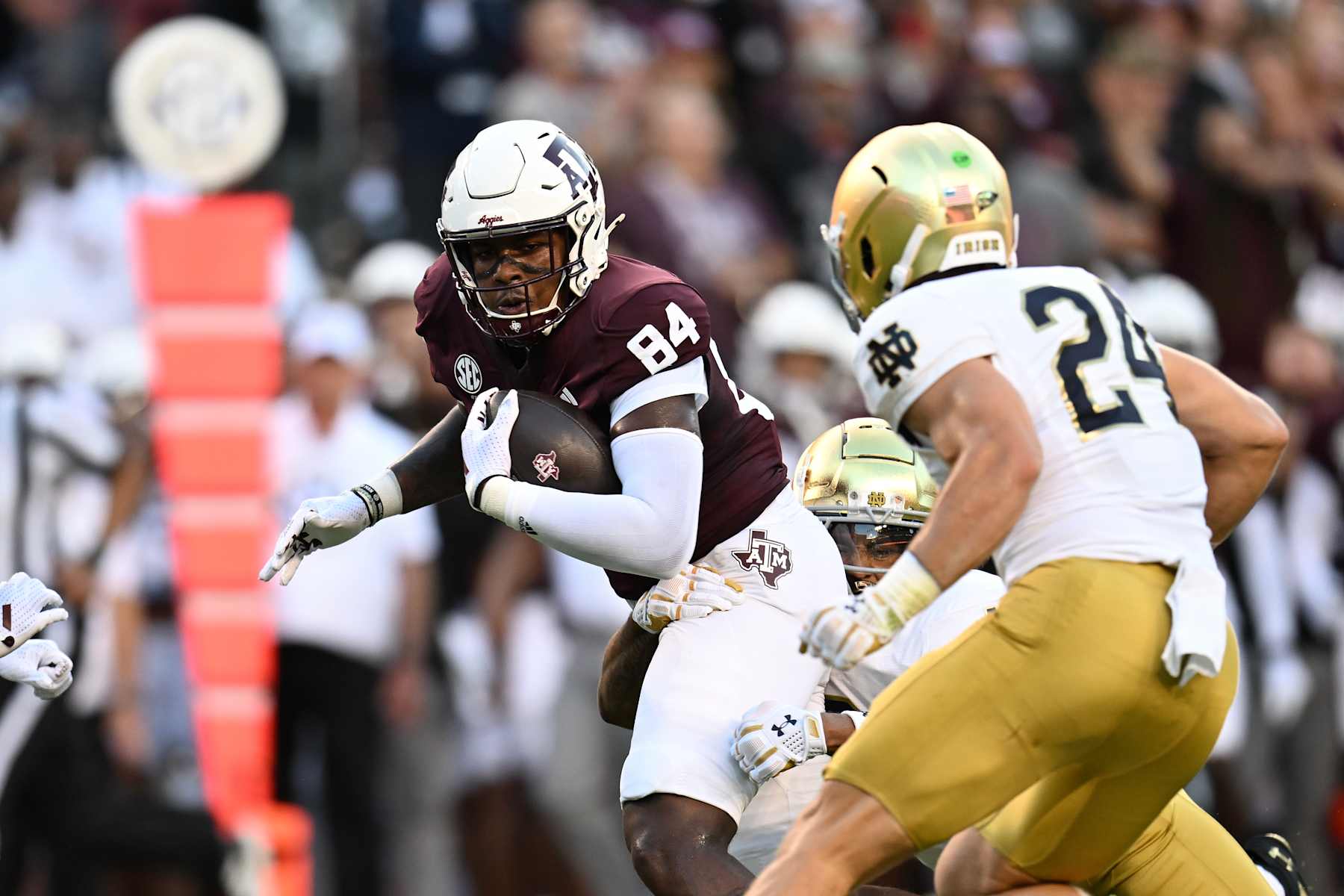 COLLEGE STATION, TEXAS - AUGUST 31: Tre Watson #84 of the Texas A&M Aggies runs after catching a pass as he is tackled by the Notre Dame Fighting Irish defense during the first quarter at Kyle Field on August 31, 2024 in College Station, Texas. (Photo by Jack Gorman/Getty Images)