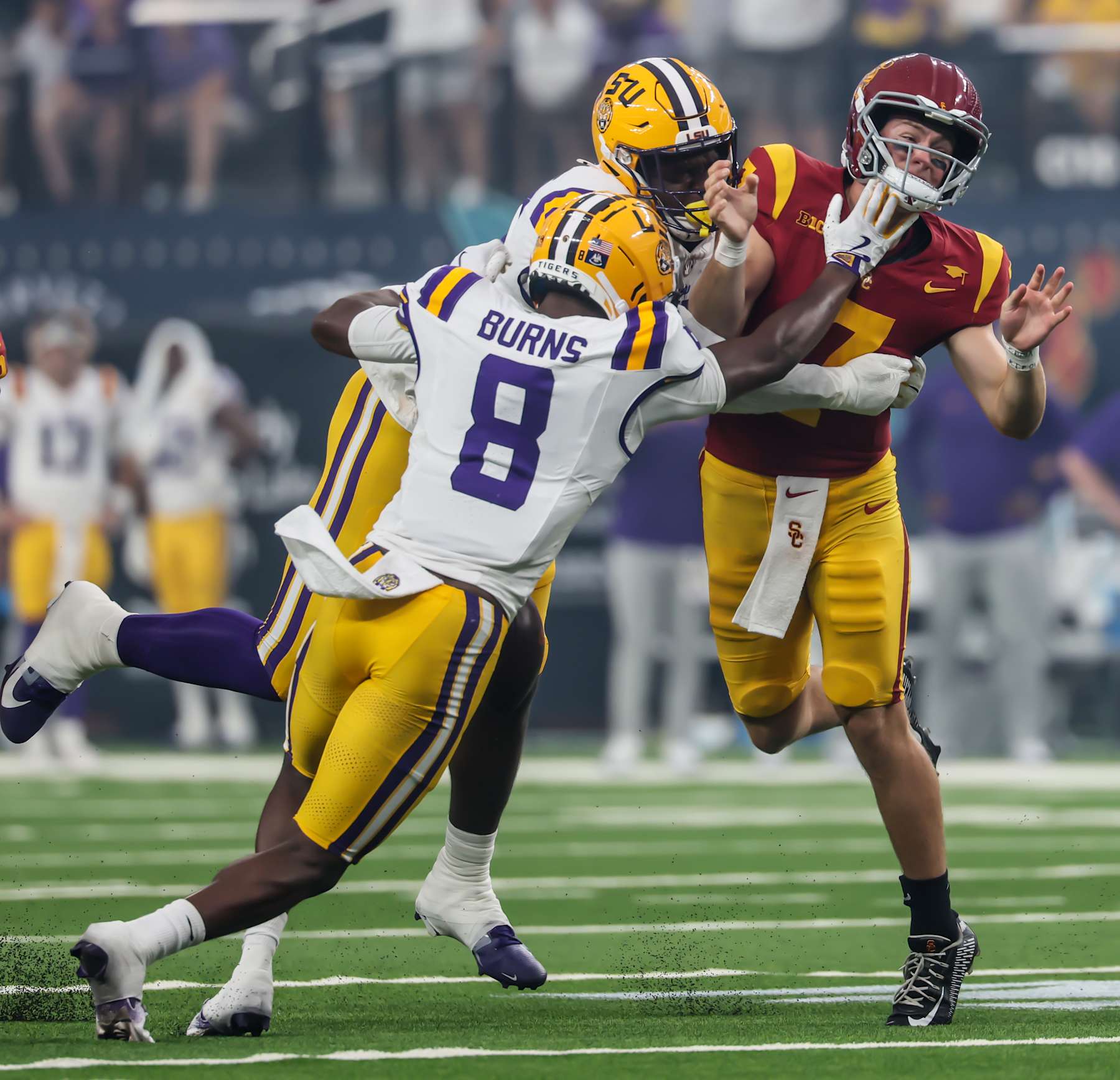 Las Vegas, Nevada, Sunday, September 1, 2024 - USC Trojans quarterback Miller Moss (7) fumbles as he is hit by  LSU Tigers defensive end Sai'vion Jones (35) safety Major Burns (8) in the first half of the Modelo Vegas Kickoff Classic at Allegiant Stadium. (Robert Gauthier/Los Angeles Times via Getty Images)
