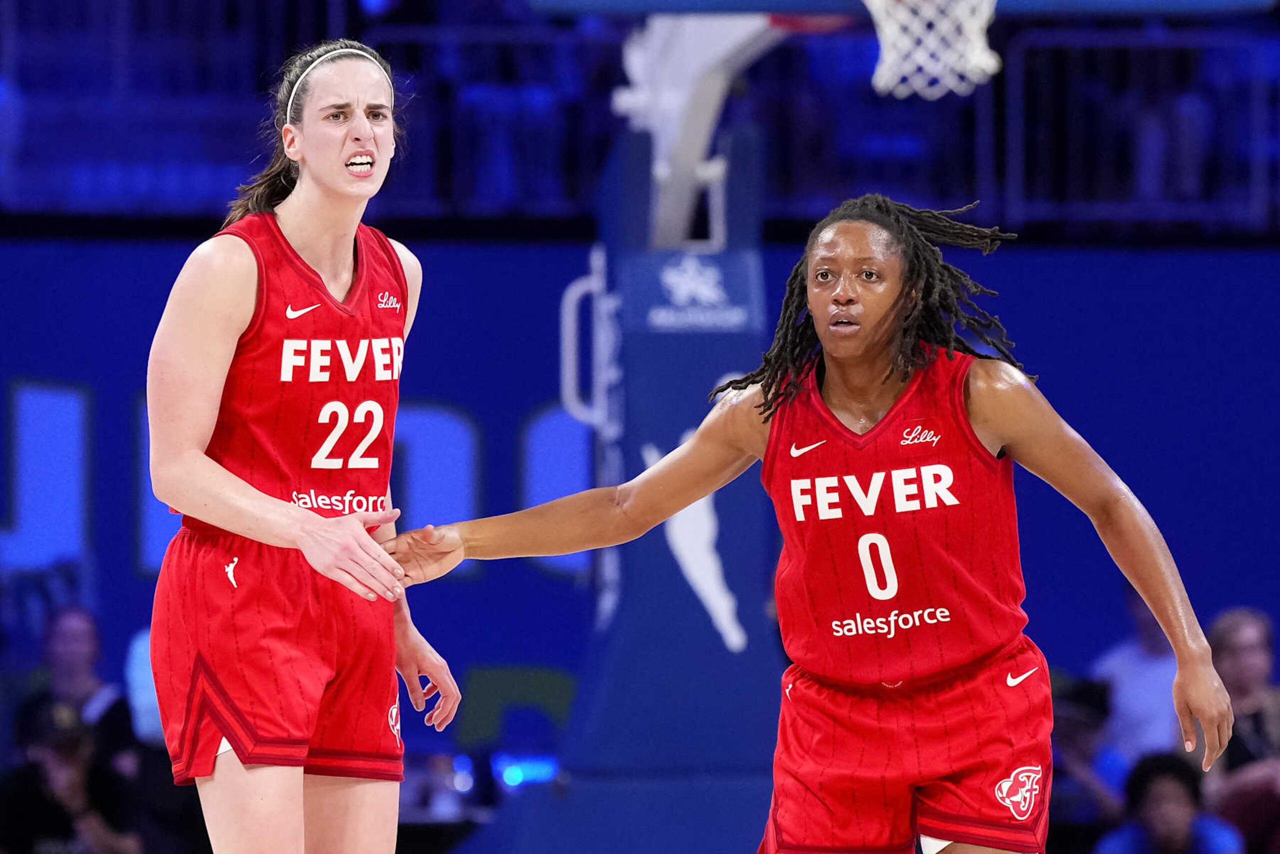 ARLINGTON, TEXAS - SEPTEMBER 01: Kelsey Mitchell #0 of the Indiana Fever celebrates scoring with Caitlin Clark #22 in the second half against the Dallas Wings at College Park Center on September 01, 2024 in Arlington, Texas. NOTE TO USER: User expressly acknowledges and agrees that, by downloading and or using this photograph, User is consenting to the terms and conditions of the Getty Images License Agreement. (Photo by Sam Hodde/Getty Images)