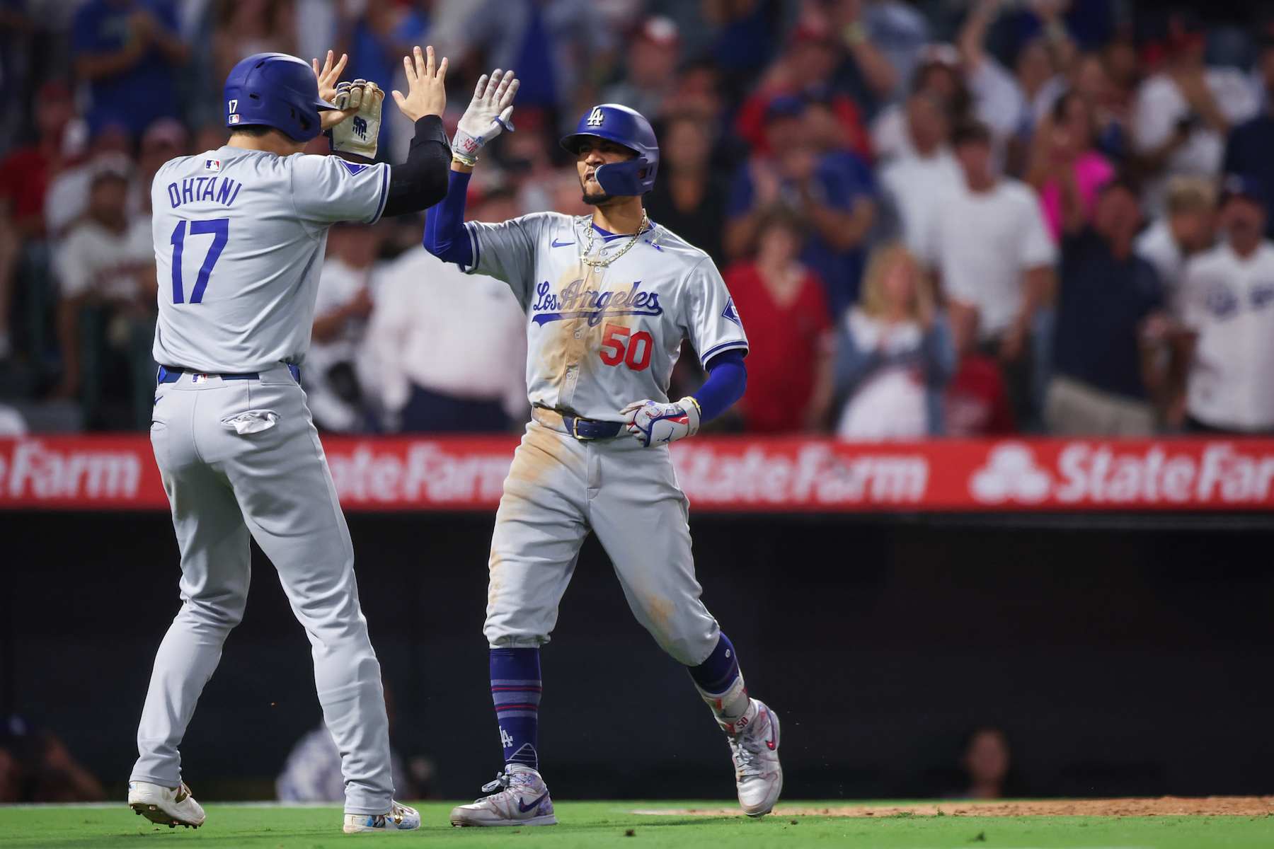ANAHEIM, CALIFORNIA - SEPTEMBER 03: Mookie Betts #50 of the Los Angeles Dodgers reacts with Shohei Ohtani #17 after hitting a three run home run in the tenth inning against the Los Angeles Angels at Angel Stadium of Anaheim on September 03, 2024 in Anaheim, California. (Photo by Meg Oliphant/Getty Images)