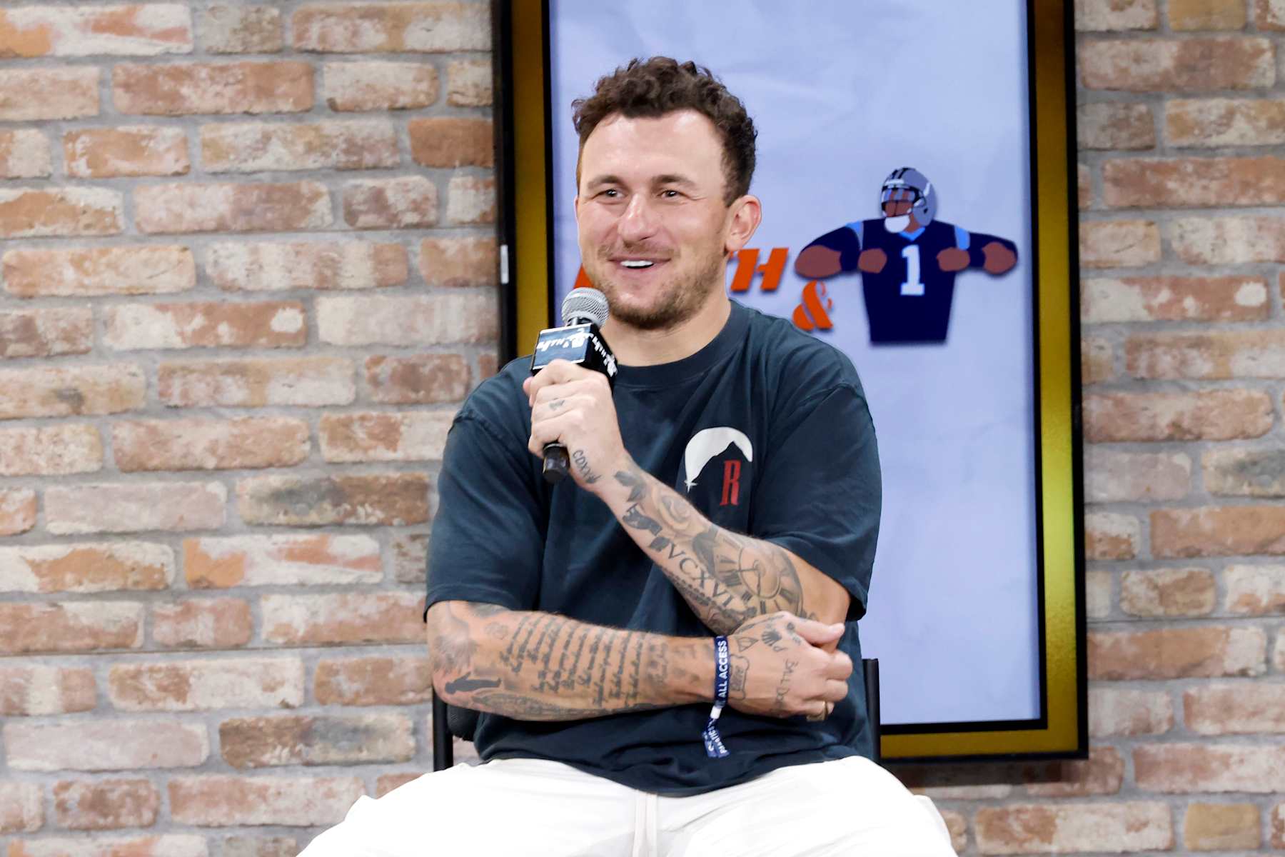 NEW YORK, NEW YORK - AUGUST 16: Johnny Manziel speaks onstage at the Fanatics Fest NYC 2024 at Jacob Javits Center on August 16, 2024 in New York City.  (Photo by Rob Kim/Getty Images for Fanatics)