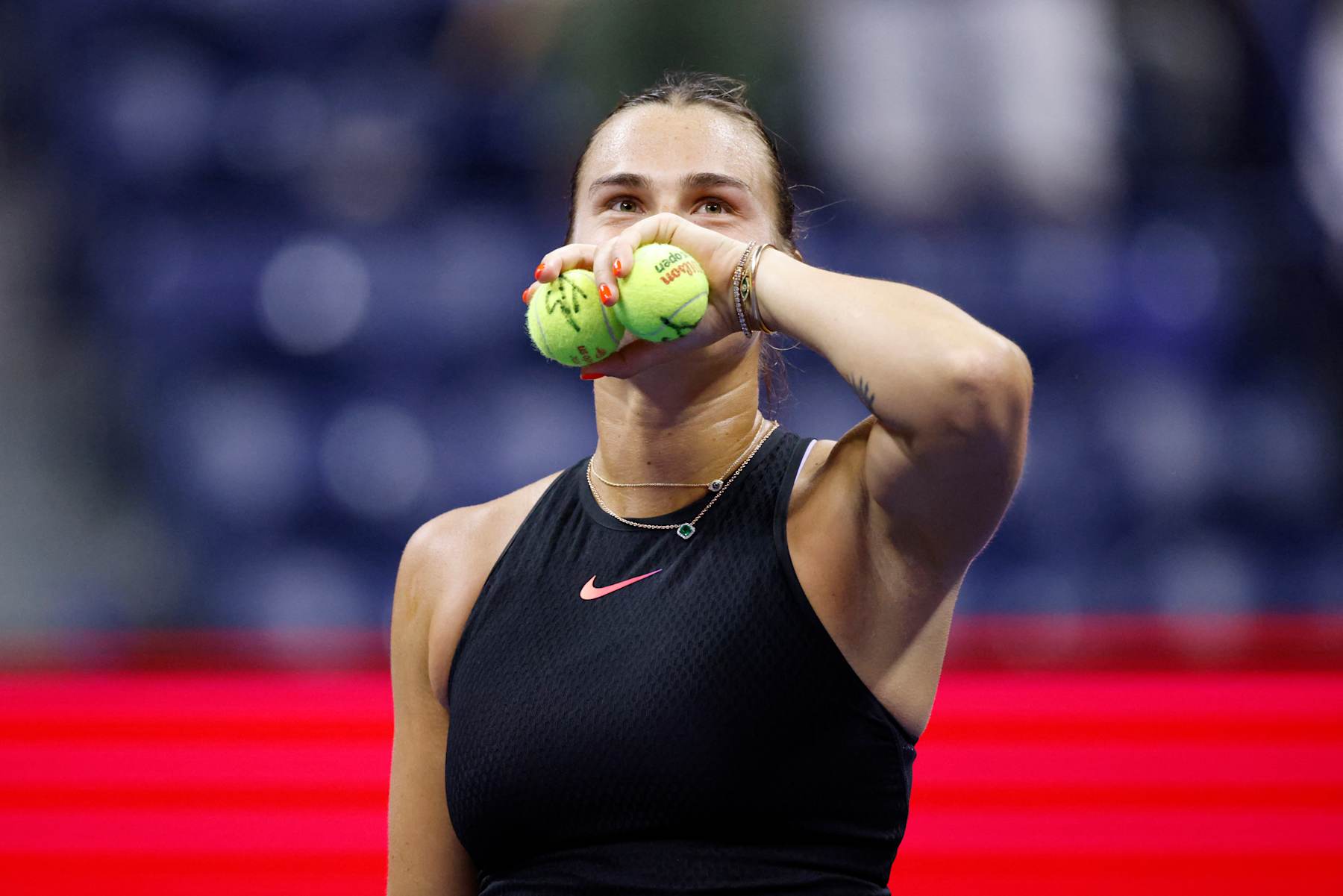 Belarus's Aryna Sabalenka prepares to throw signed tennis balls to fans after winning her women's quarterfinals match against China's Zheng Qinwen on day nine of the US Open tennis tournament at the USTA Billie Jean King National Tennis Center in New York City, on September 3, 2024. (Photo by KENA BETANCUR / AFP) (Photo by KENA BETANCUR/AFP via Getty Images)