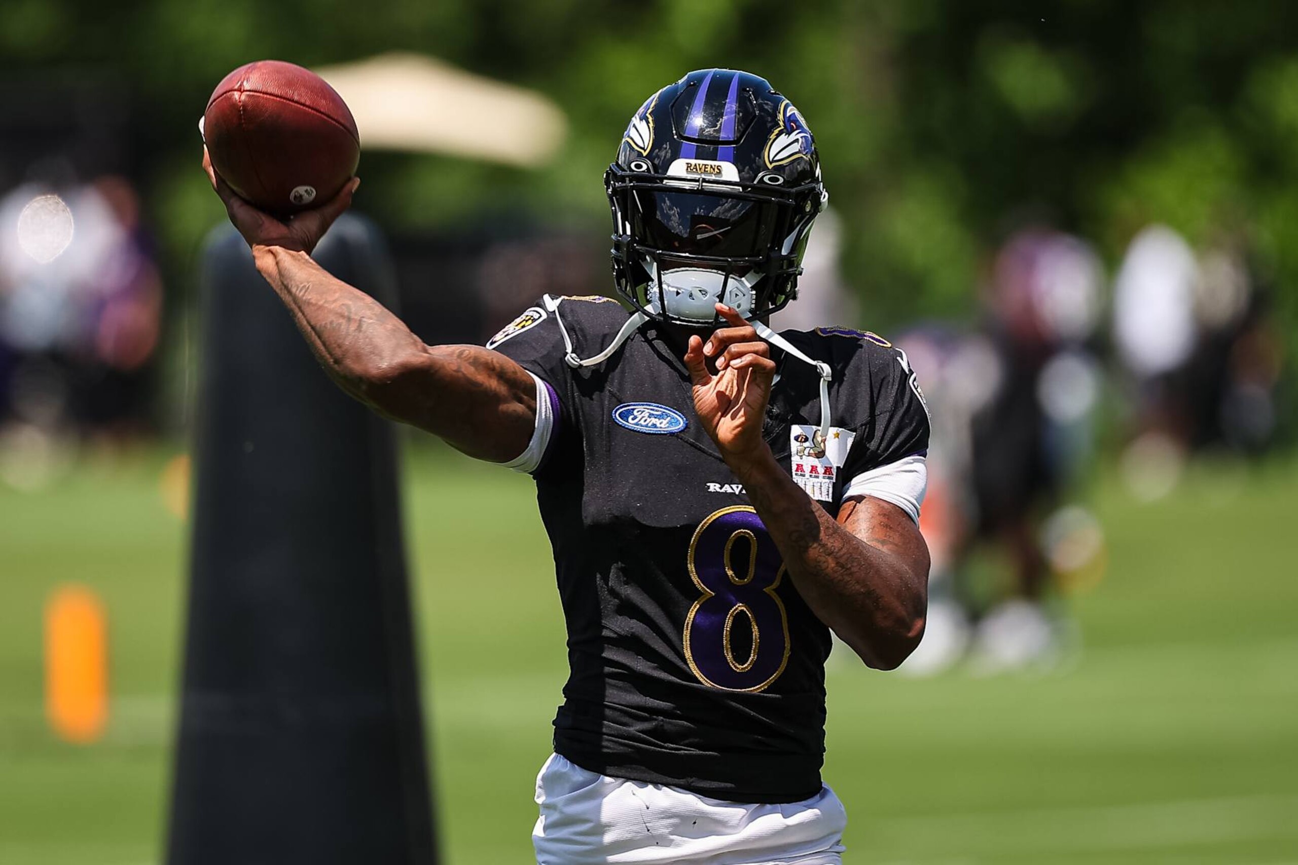 OWINGS MILLS, MD - AUGUST 12: Lamar Jackson #8 of the Baltimore Ravens attempts a pass during training camp at Under Armour Performance Center Baltimore Ravens on August 12, 2024 in Owings Mills, Maryland. (Photo by Scott Taetsch/Getty Images)