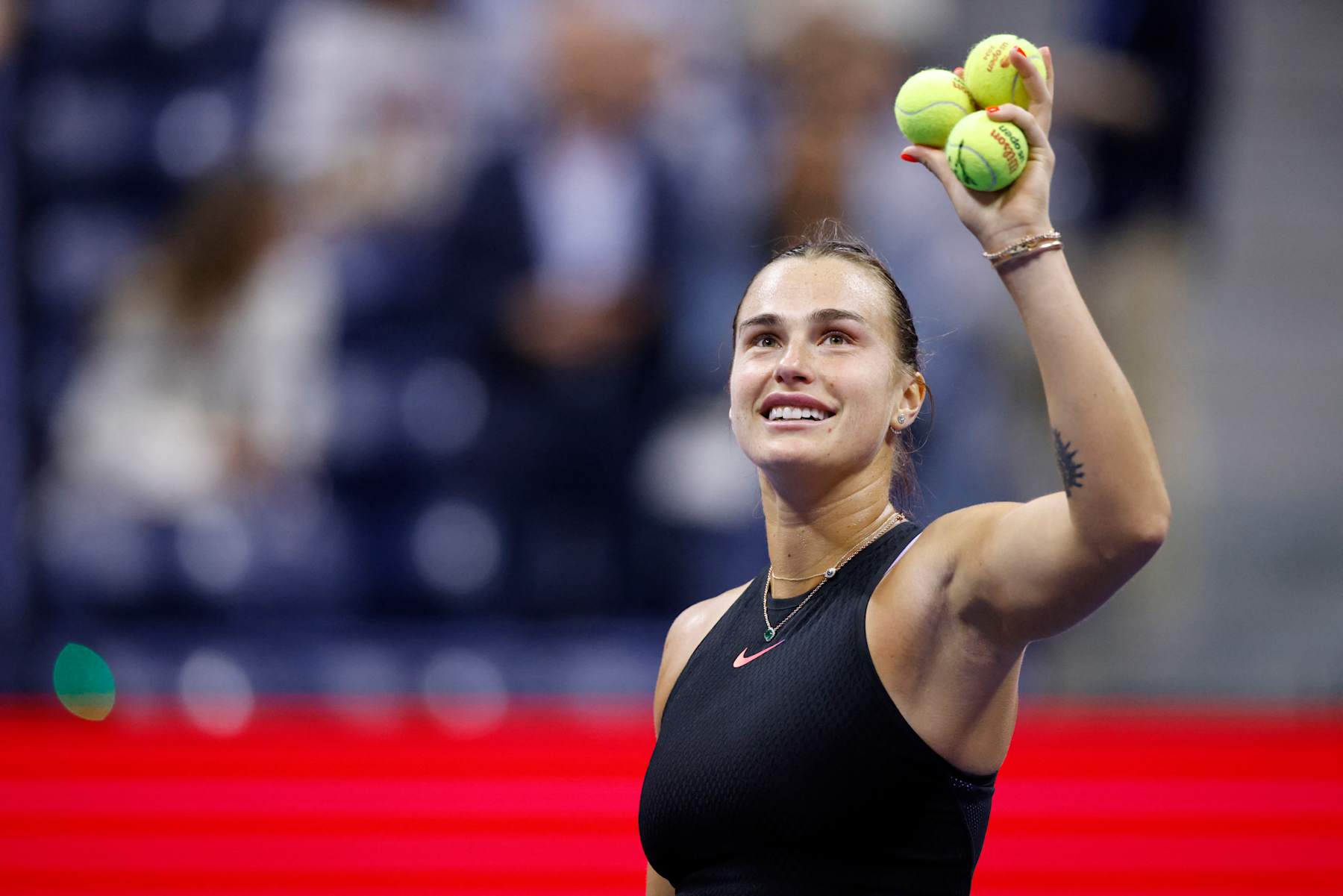 Belarus's Aryna Sabalenka prepares to throw signed tennis balls to fans after winning her women's quarterfinals match against China's Zheng Qinwen on day nine of the US Open tennis tournament at the USTA Billie Jean King National Tennis Center in New York City, on September 3, 2024. (Photo by KENA BETANCUR / AFP) (Photo by KENA BETANCUR/AFP via Getty Images)