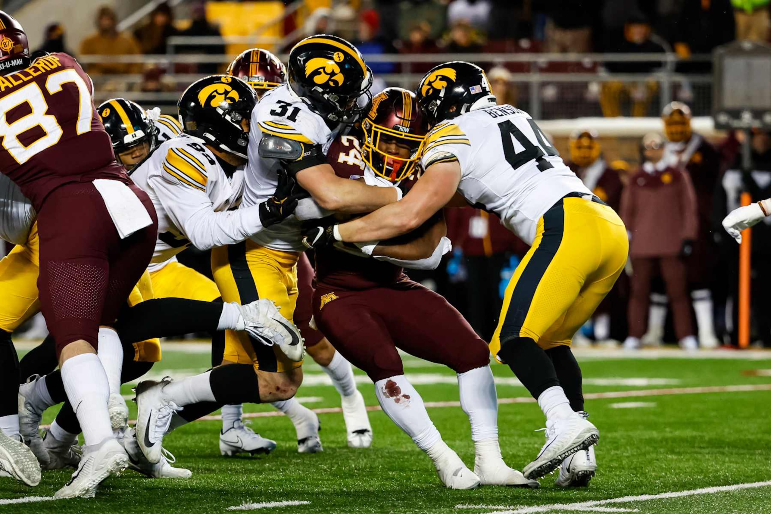 MINNEAPOLIS, MN - NOVEMBER 19: Mohamed Ibrahim #24 of the Minnesota Golden Gophers is tackled by Jack Campbell #31 and Seth Benson #44 of the Iowa Hawkeyes in the third quarter of the game at Huntington Bank Stadium on November 19, 2022 in Minneapolis, Minnesota. The Hawkeyes defeated the Golden Gophers 13-10. (Photo by David Berding/Getty Images)