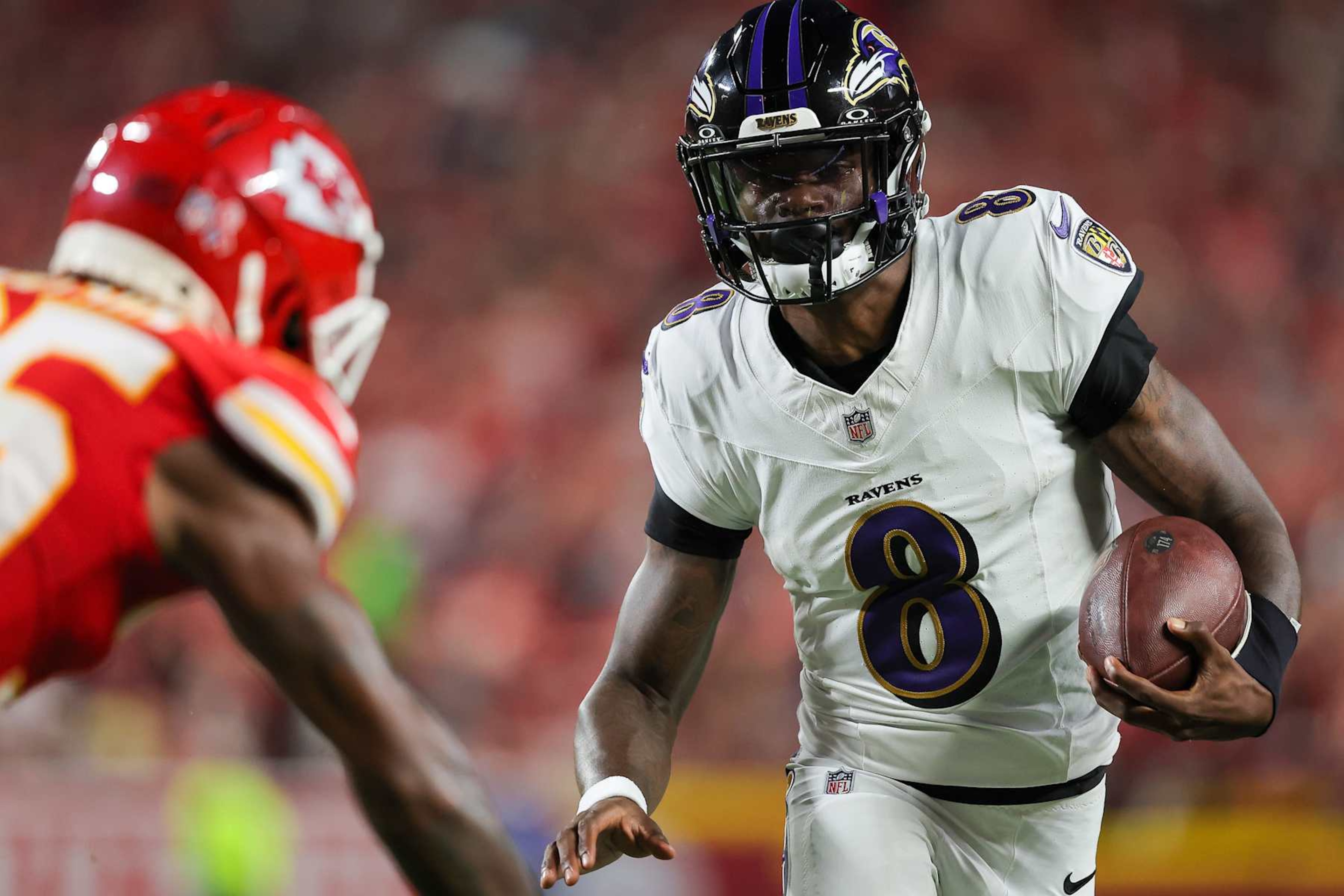 KANSAS CITY, MISSOURI - SEPTEMBER 05: Quarterback Lamar Jackson of the Baltimore Ravens runs for a first down against the Kansas City Chiefs during the first quarter at GEHA Field at Arrowhead Stadium on September 05, 2024 in Kansas City, Missouri. (Photo by David Eulitt/Getty Images)