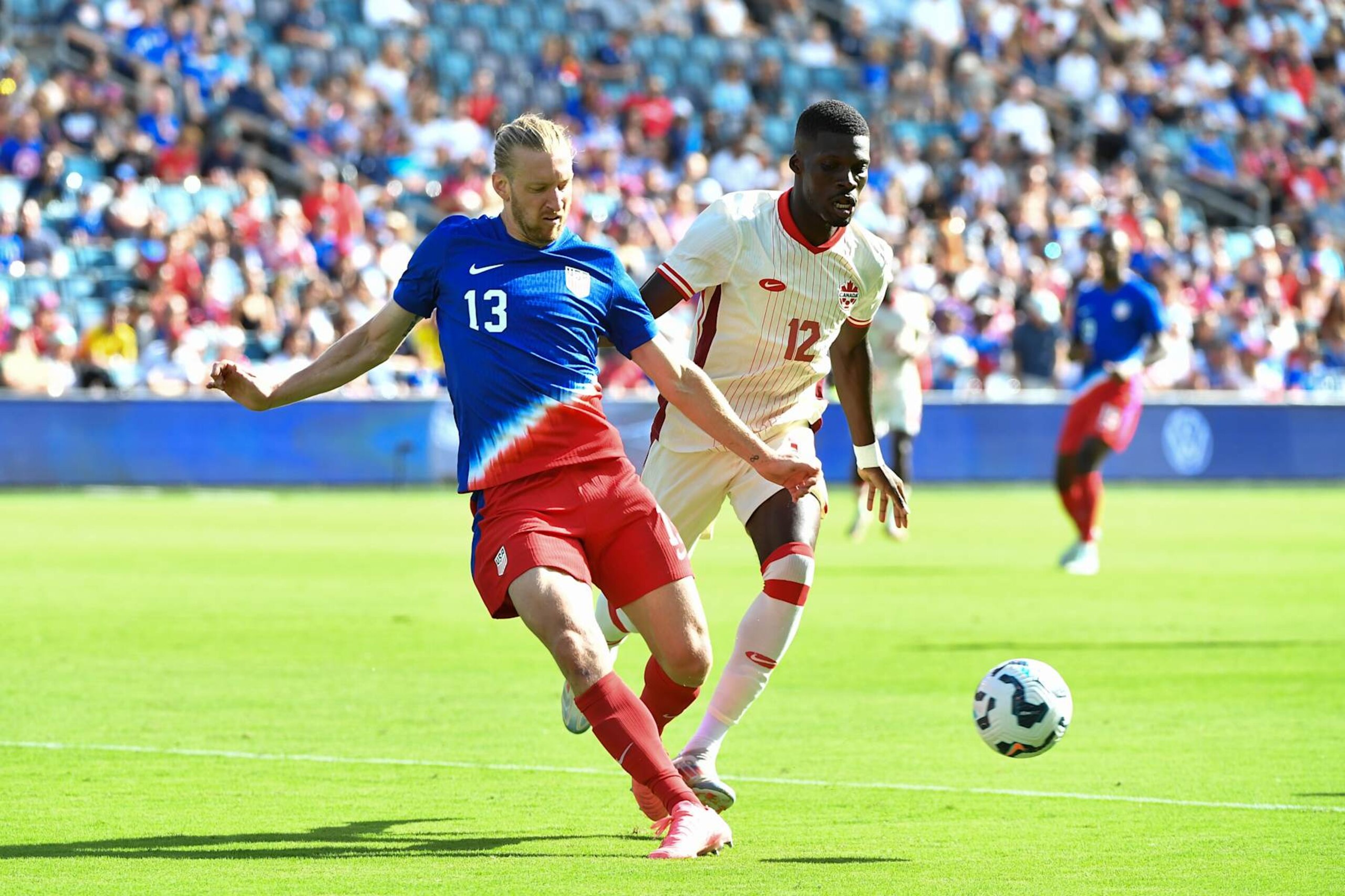 KANSAS CITY, KANSAS - SEPTEMBER 07: Tim Ream #13 of the United States passes the ball while defended by Tani Oluwaseyi #12 of Canada during an international friendly between the United States and Canada at Children's Mercy Park on September 07, 2024 in Kansas City, Kansas. (Photo by Bill Barrett/ISI Photos/USSF/Getty Images)