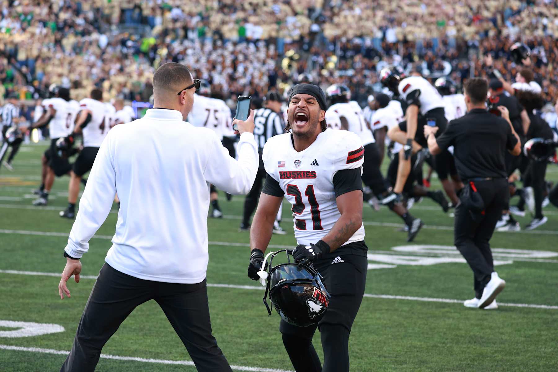 SOUTH BEND, IN - SEPTEMBER 07: Northern Illinois Huskies cornerback Dev'ion Reynolds (21) reacts to the upset victory against the Notre Dame Fighting Irish on September 7, 2024, at Notre Dame Stadium in South Bend, Indiana. (Photo by Brian Spurlock/Icon Sportswire via Getty Images)